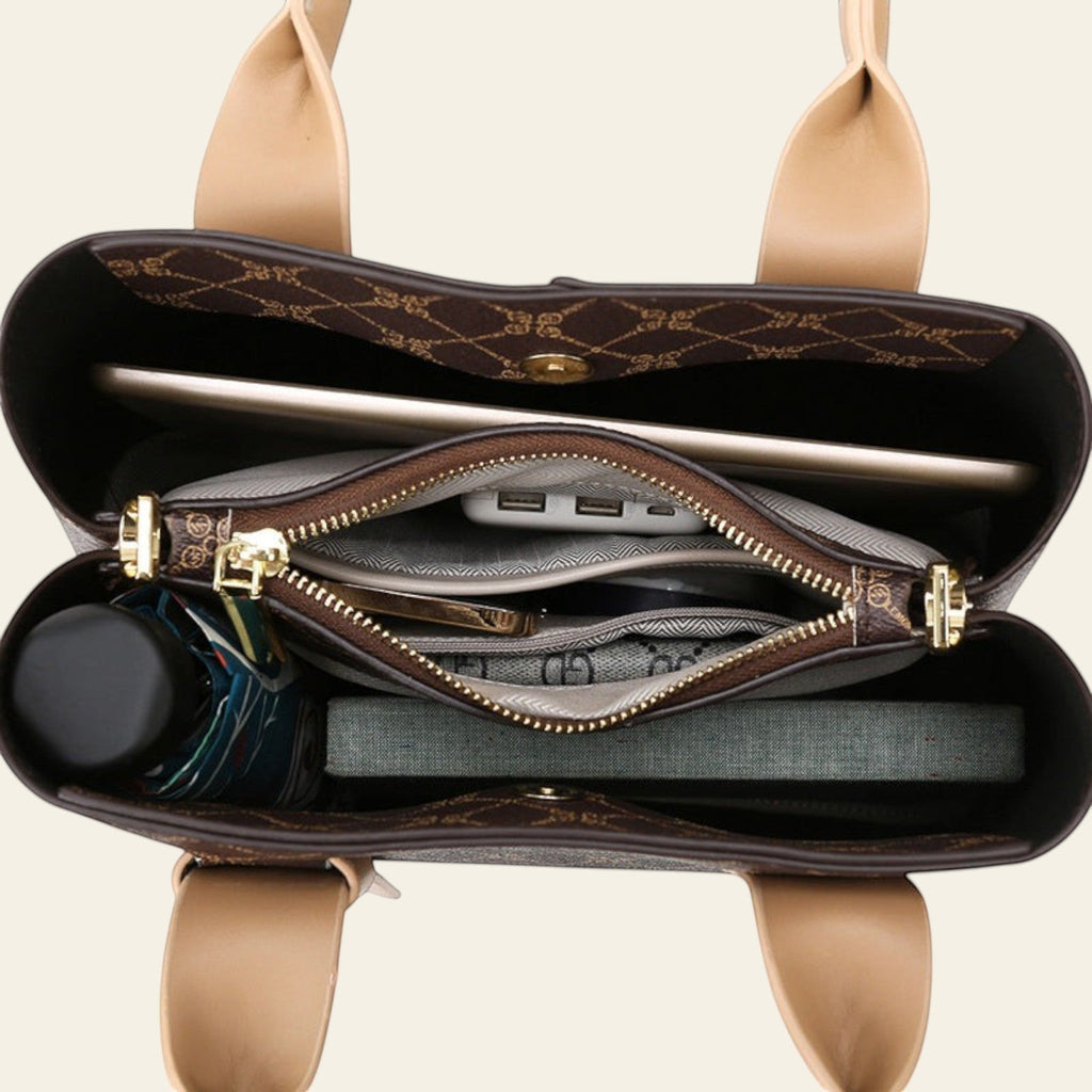 Open handbag showing interior with compartments and a phone inside, on a white background.