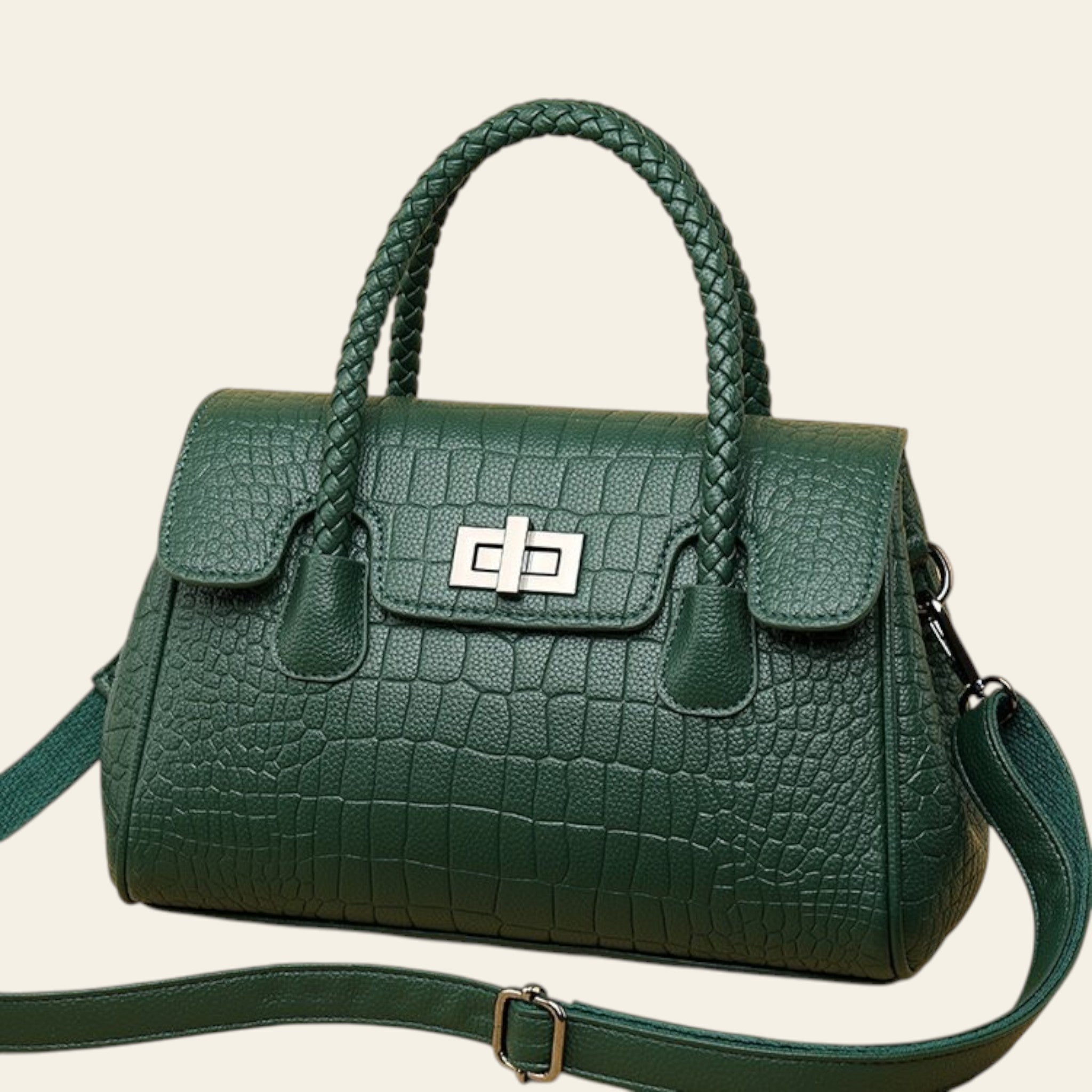 Green textured handbag with a silver clasp on a beige background