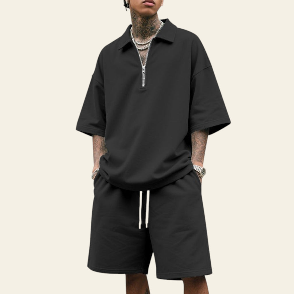 Man wearing a men's summer two-piece set with lapel short sleeve shirt and matching shorts in black color
