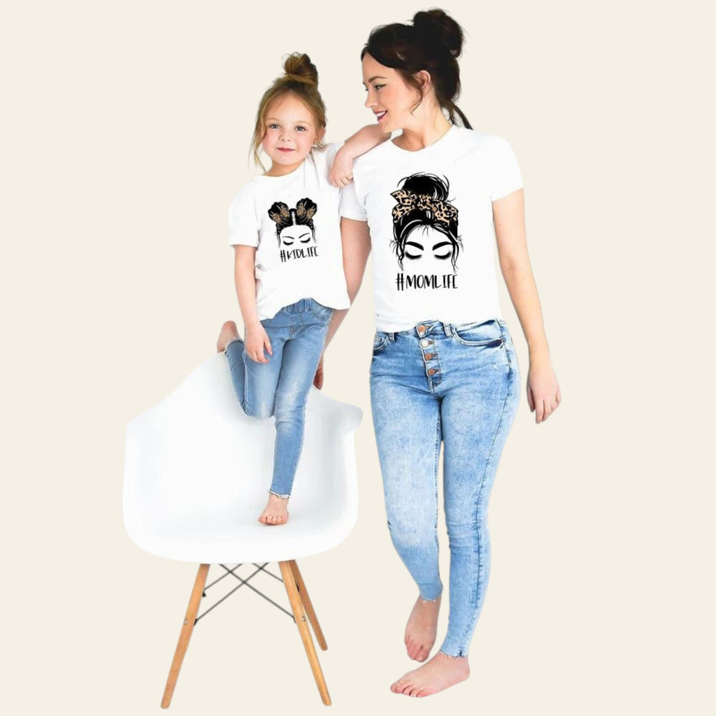 Woman and child wearing matching t-shirts with a graphic design on a white background