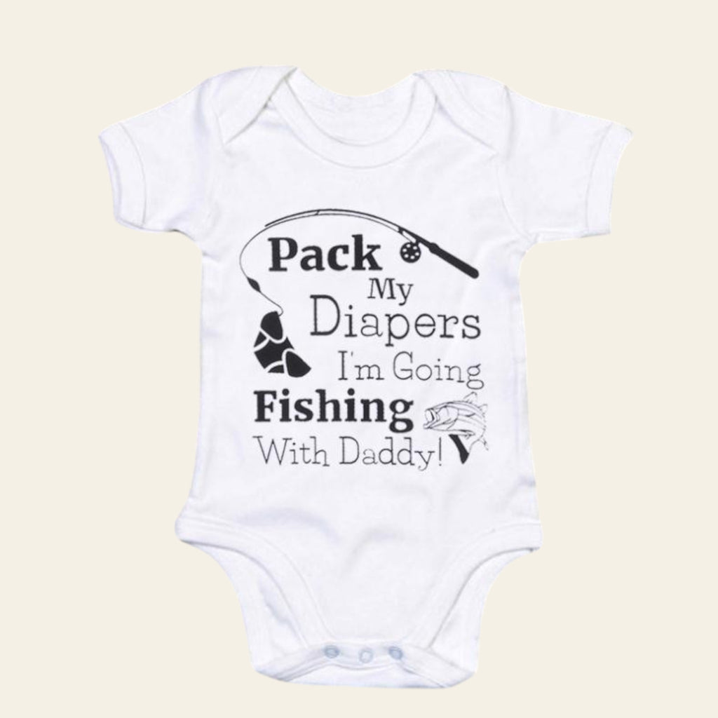 White baby onesie with text 'Pack My Diapers I'm Going Fishing With Daddy!' on a beige background