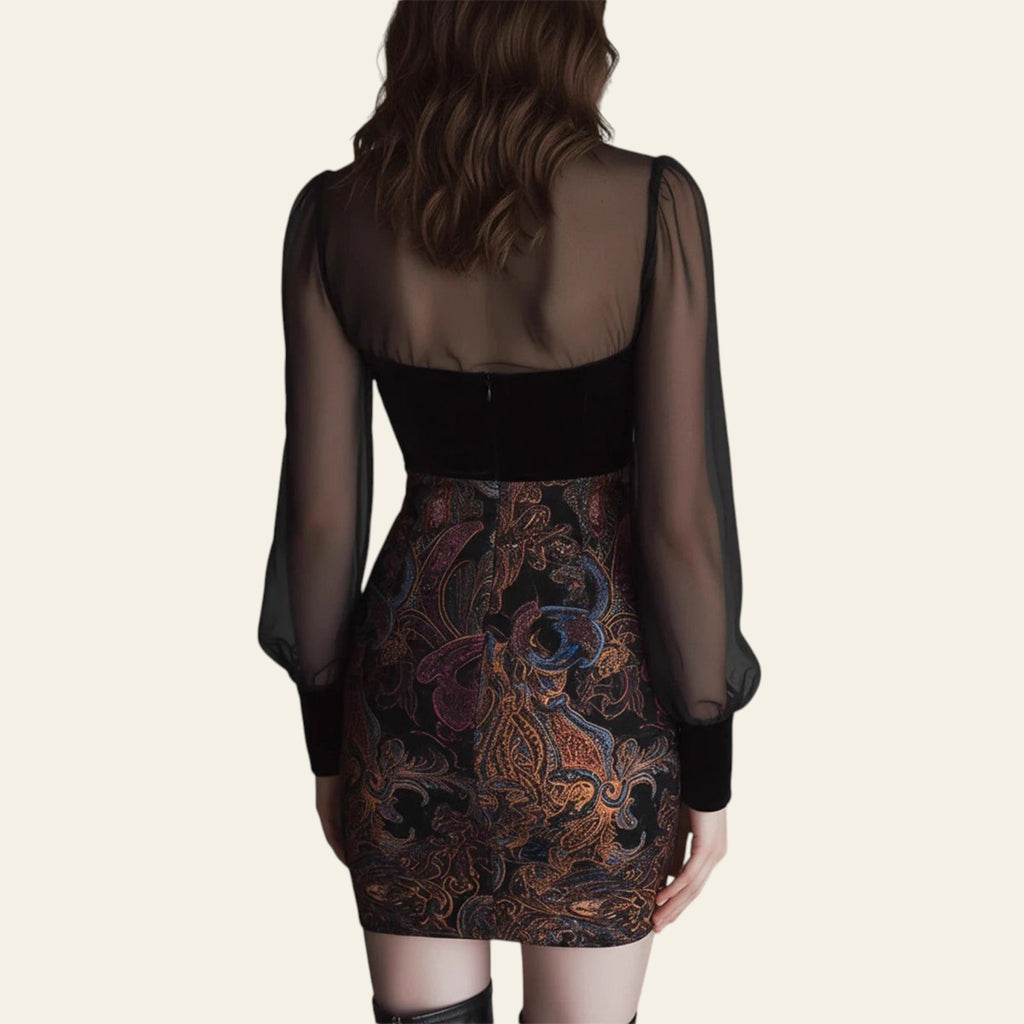 Back view of black mini dress with sheer sleeves and paisley skirt