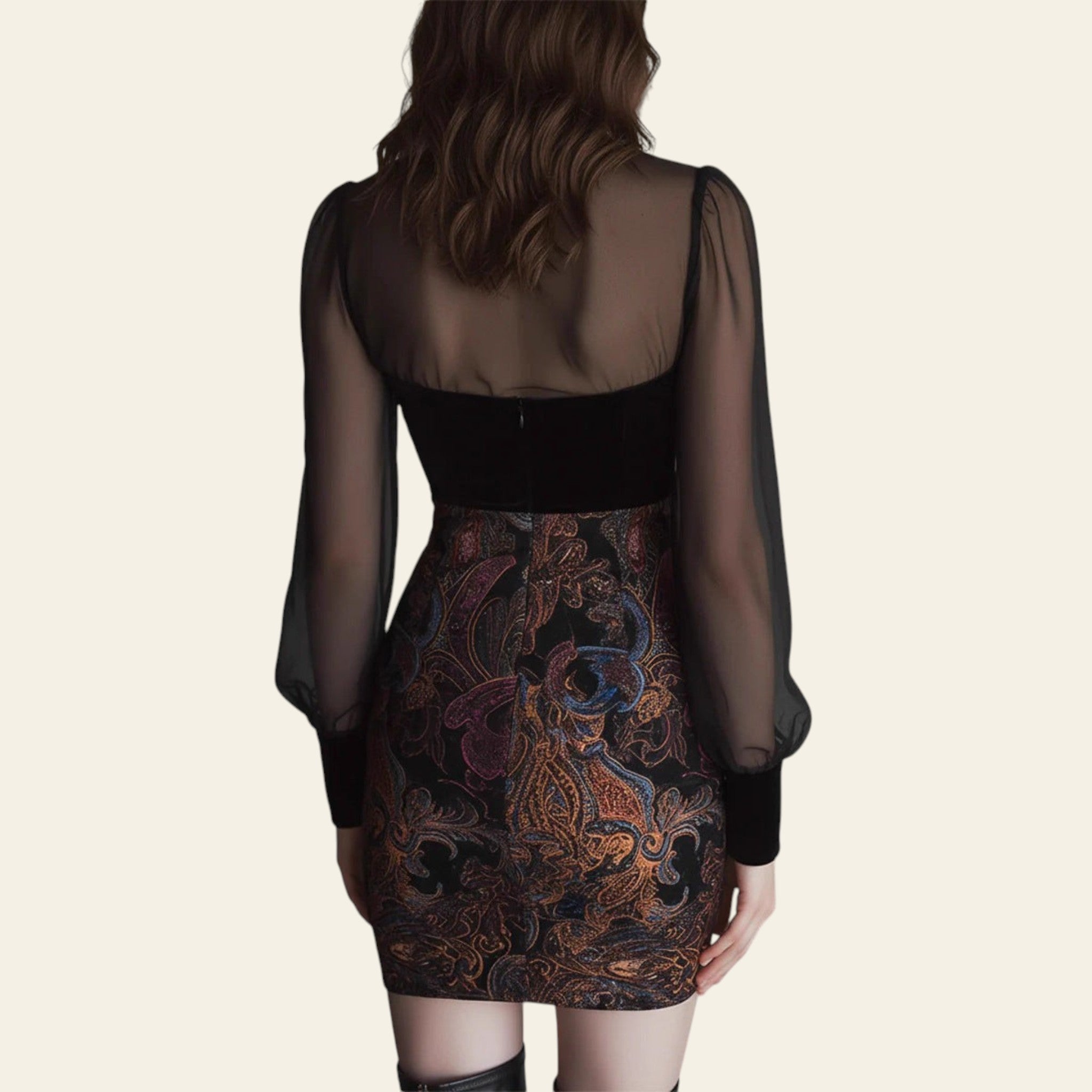 Back view of black mini dress with sheer sleeves and paisley skirt