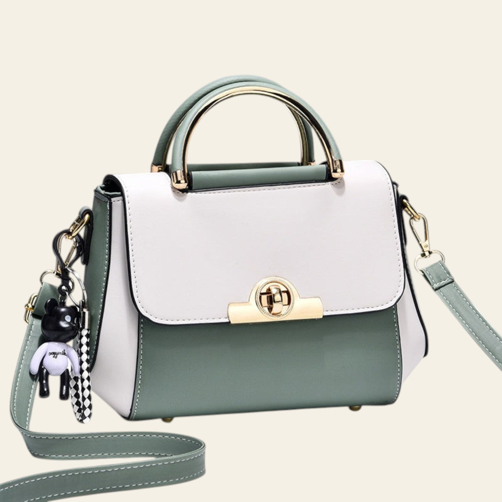 Green and white handbag with gold accents on a light gray background