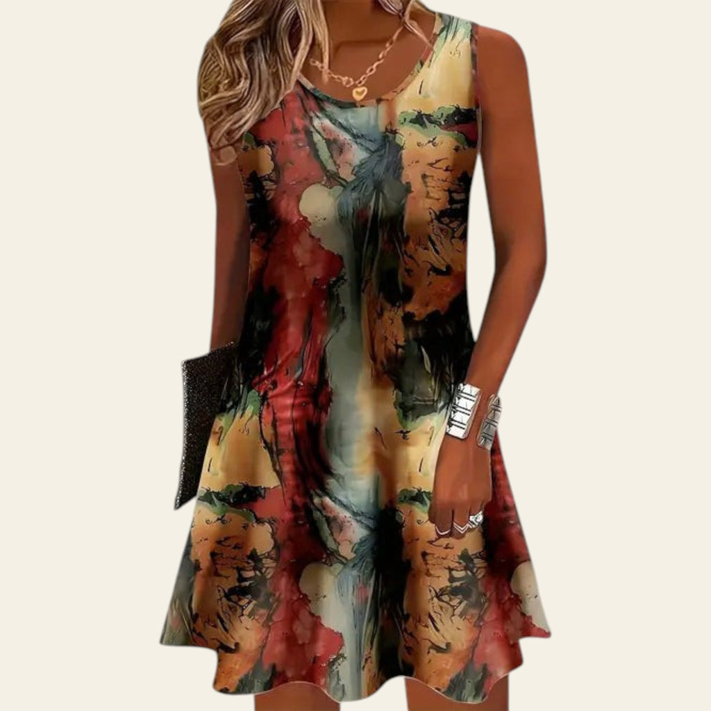 woman wearing a sleeveless multicolor abstract-pattern dress with earth tone shades