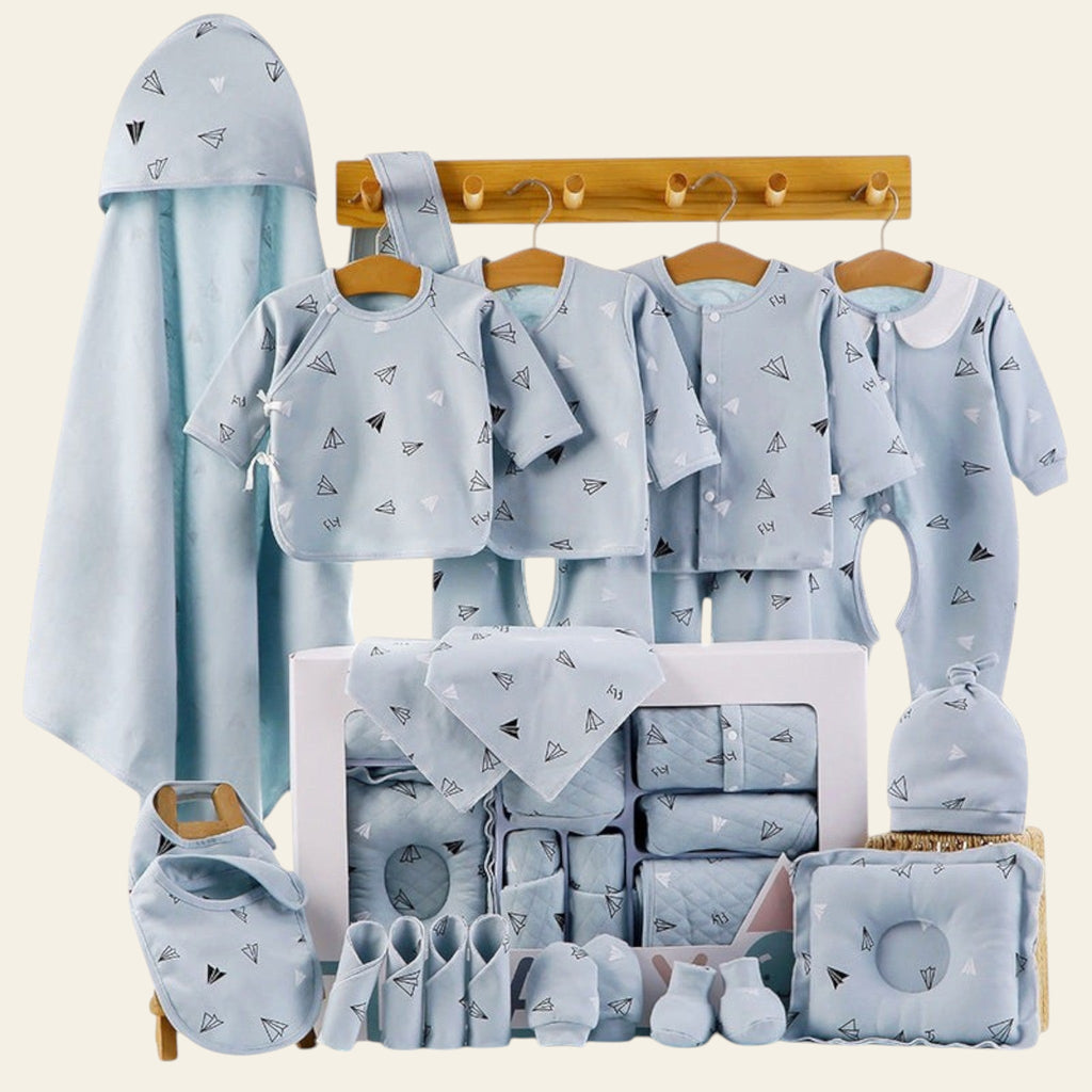 Collection of baby clothing and accessories in light blue with geometric patterns on a white background.