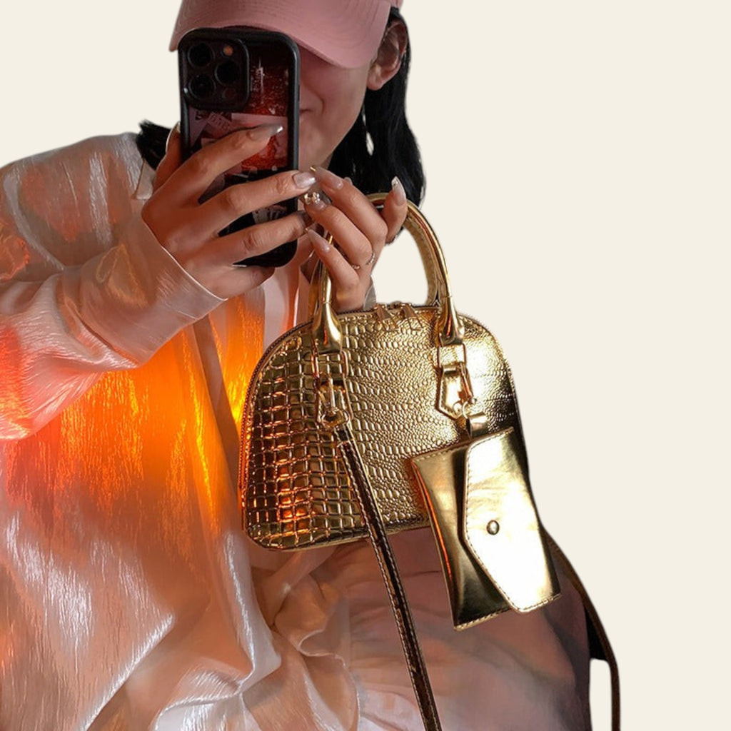 Gold textured leather handbag with structured shape and shoulder strap