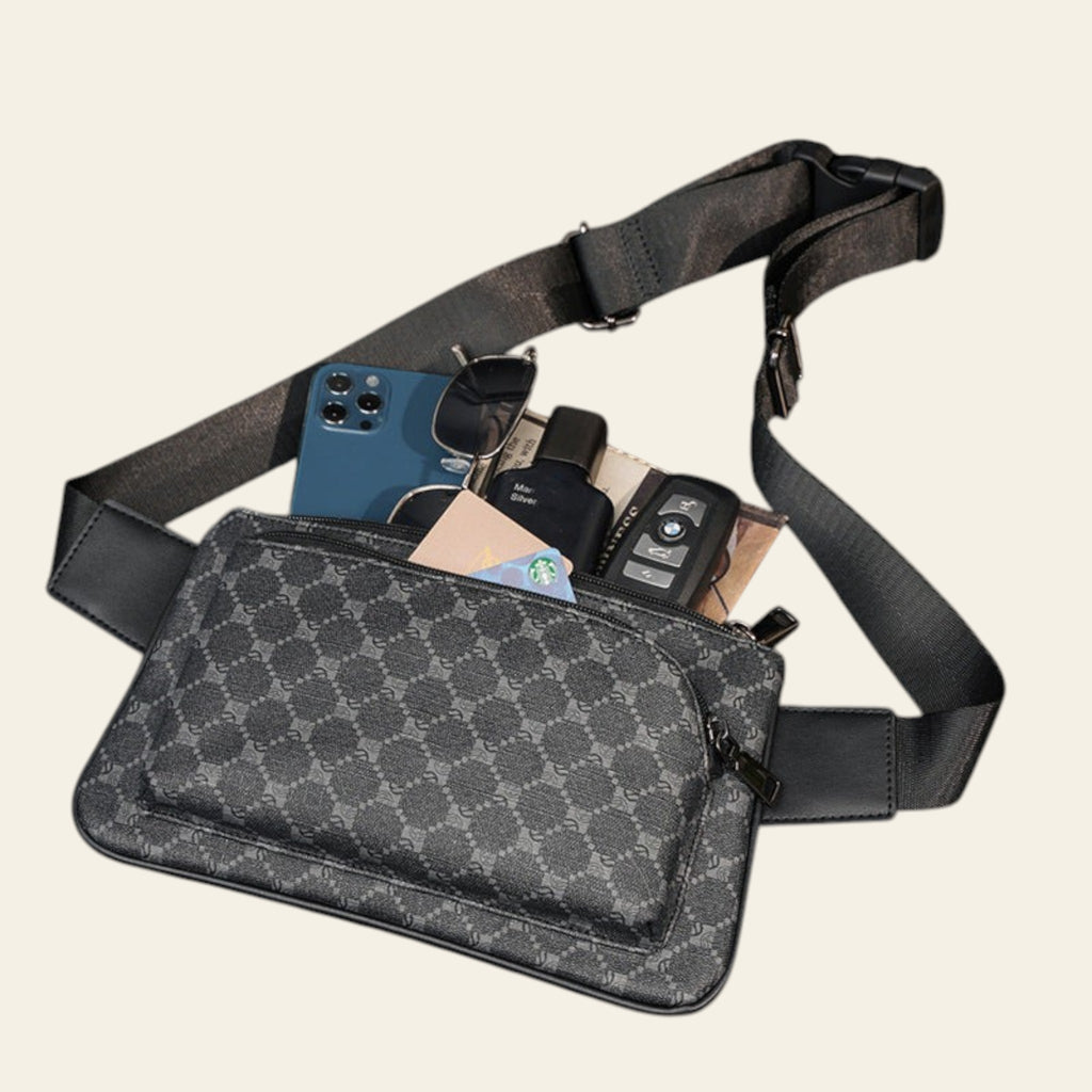 Gray patterned waist bag with items on a dark wooden surface