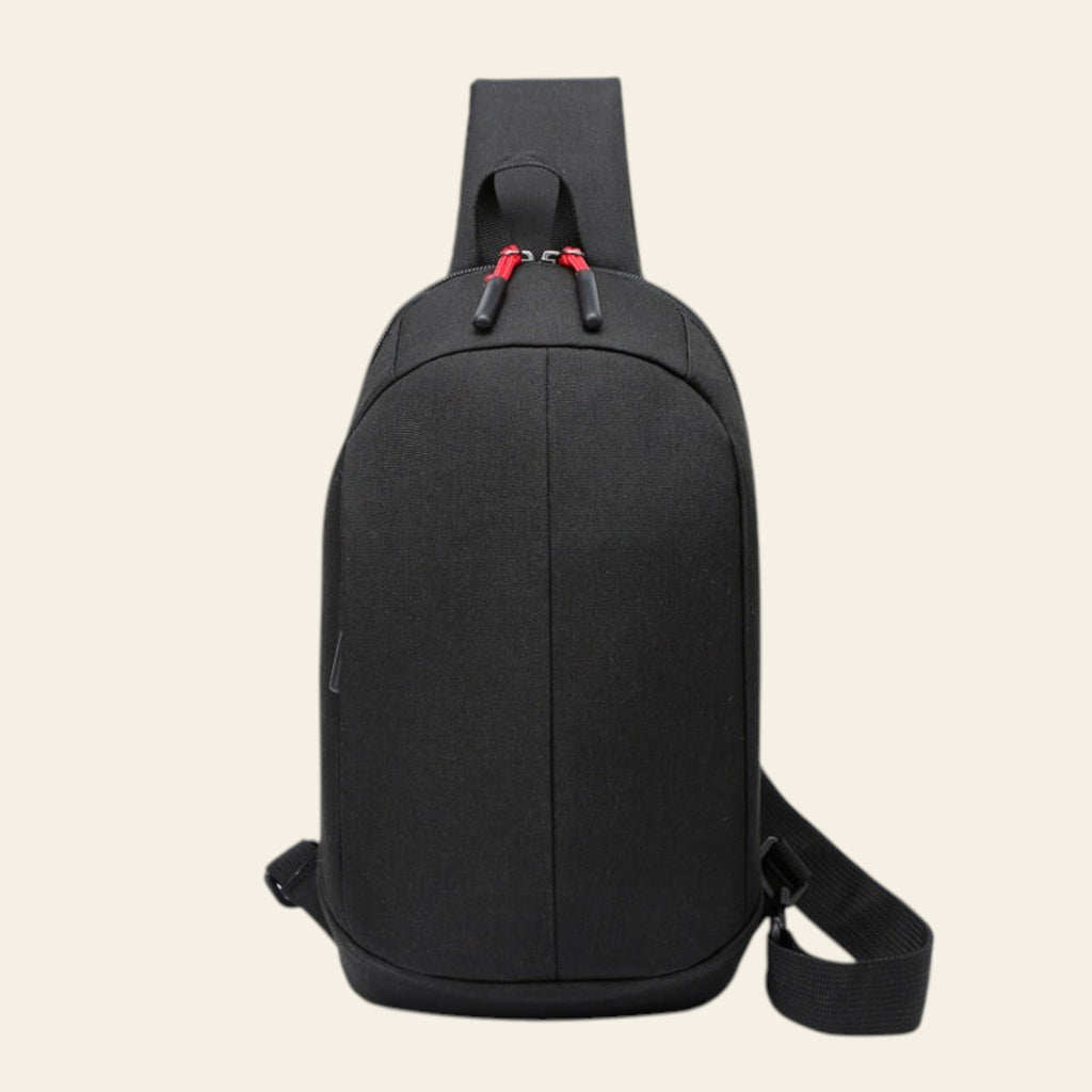 Black crossbody bag with red accents on a white background