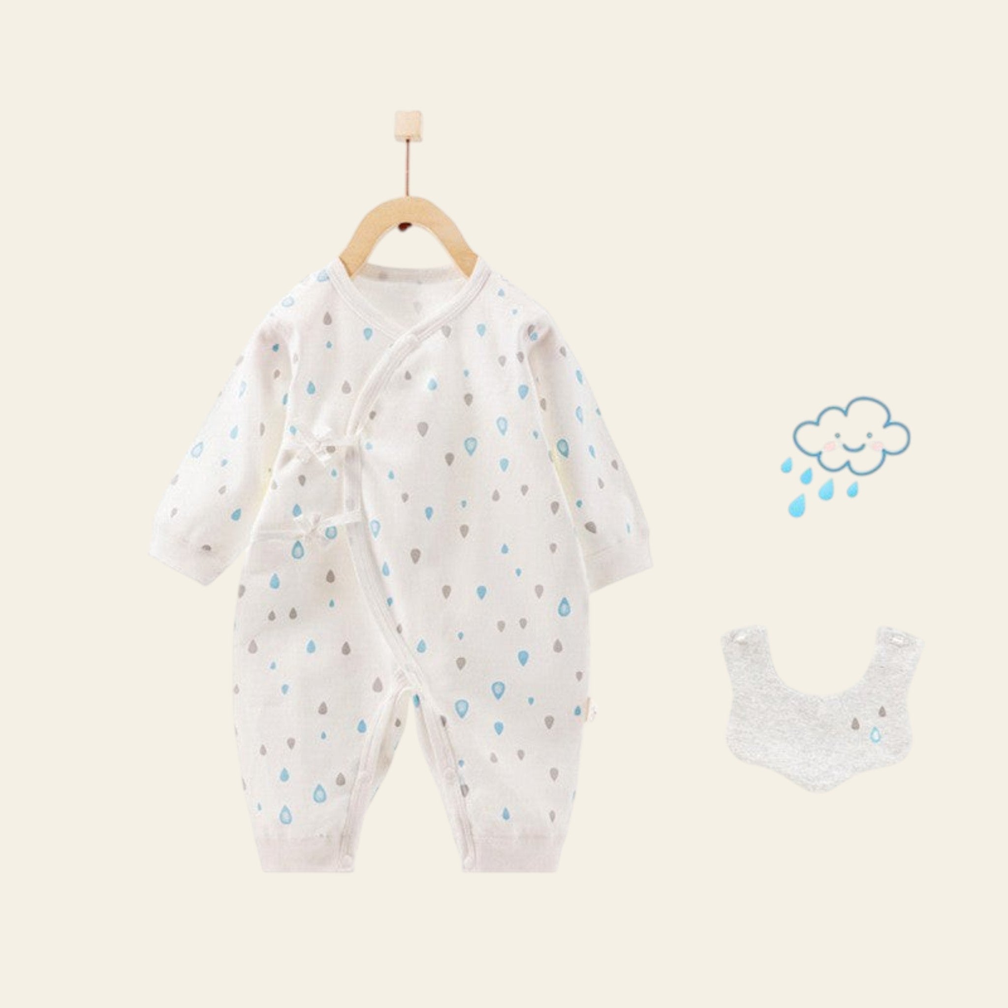 Baby onesie with cloud pattern and matching bib on a white background
