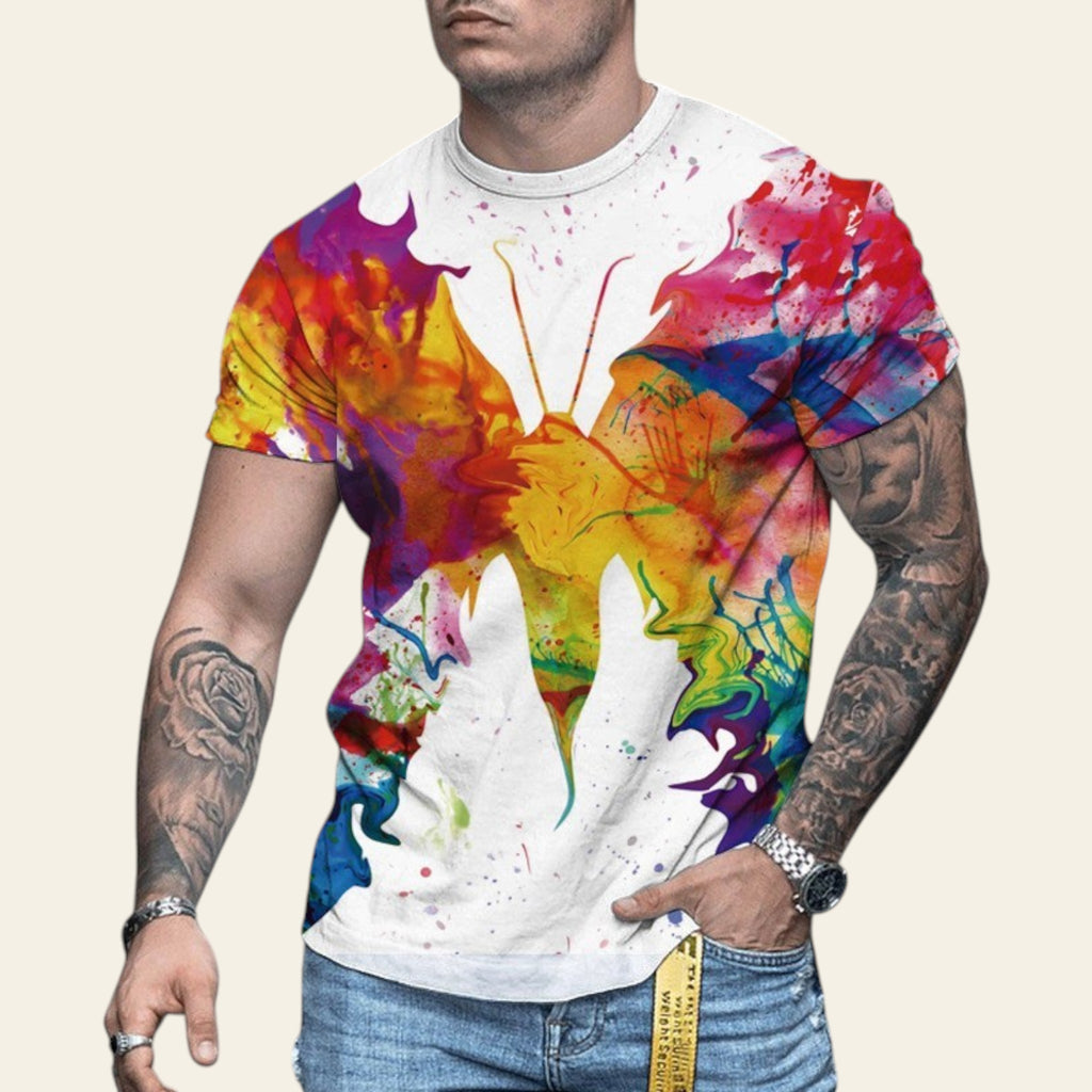 Man wearing a colorful butterfly graphic t-shirt on a blurred street background