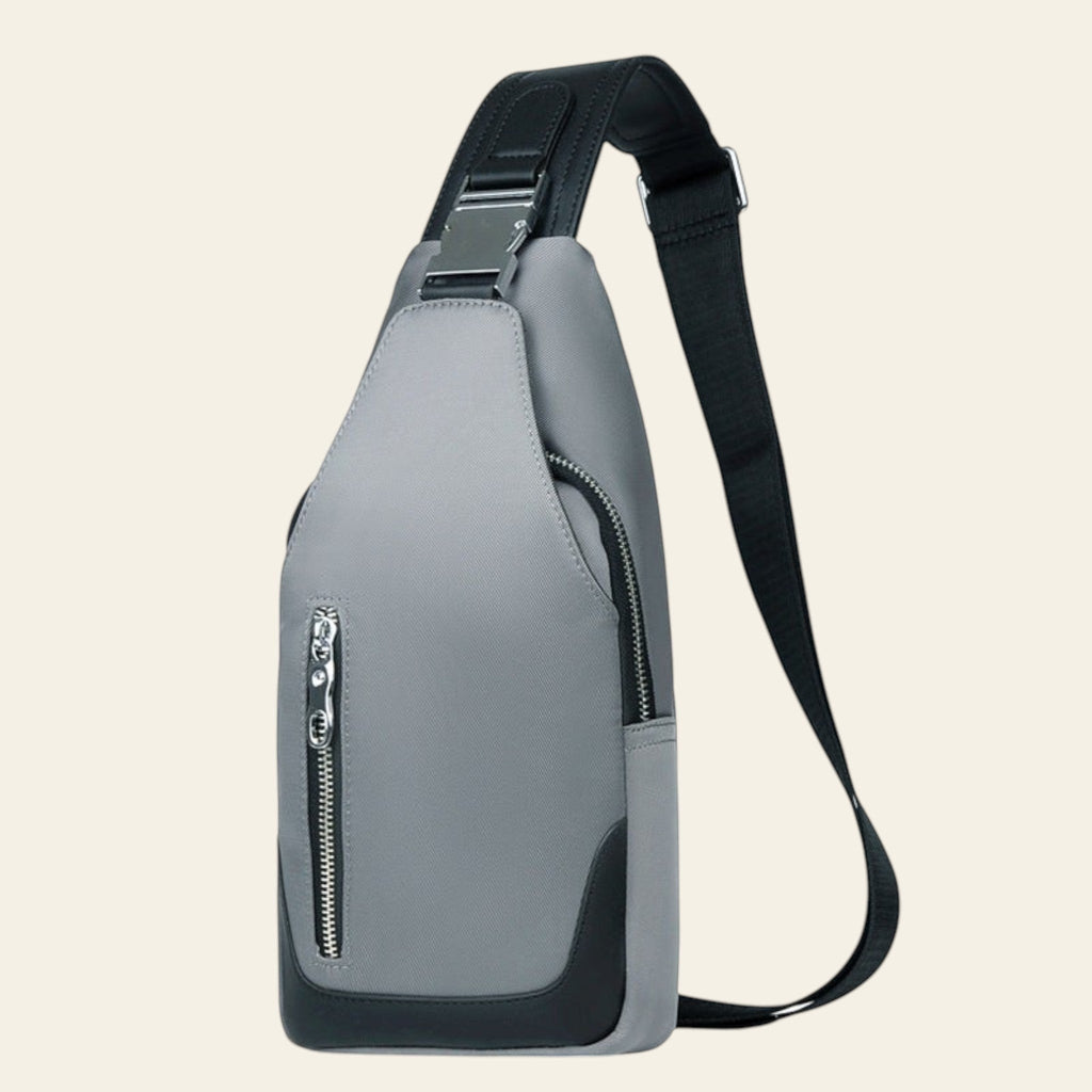 Gray sling bag with a black strap on a white background