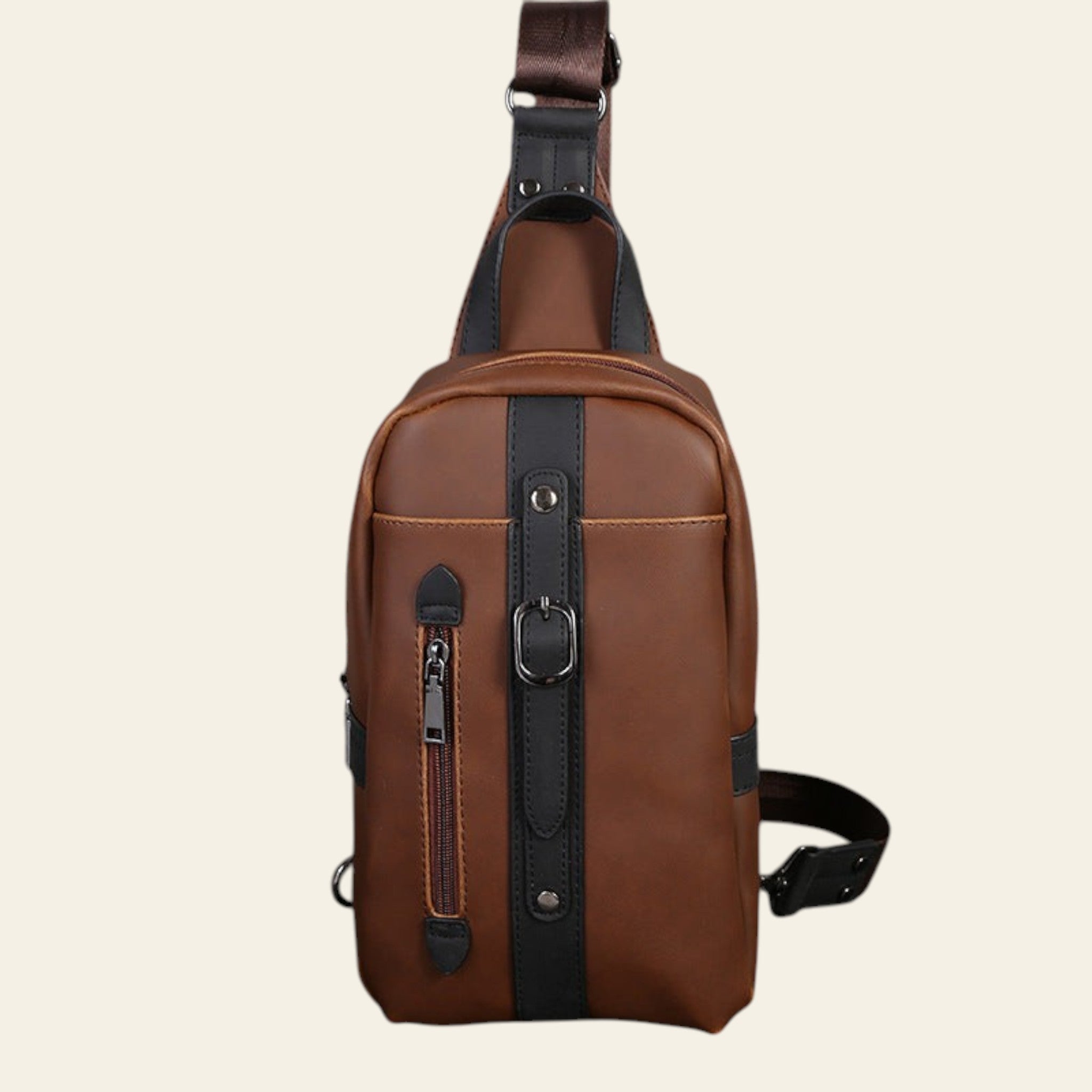Brown leather sling bag on a dark wooden surface with a grid-patterned wall in the background.