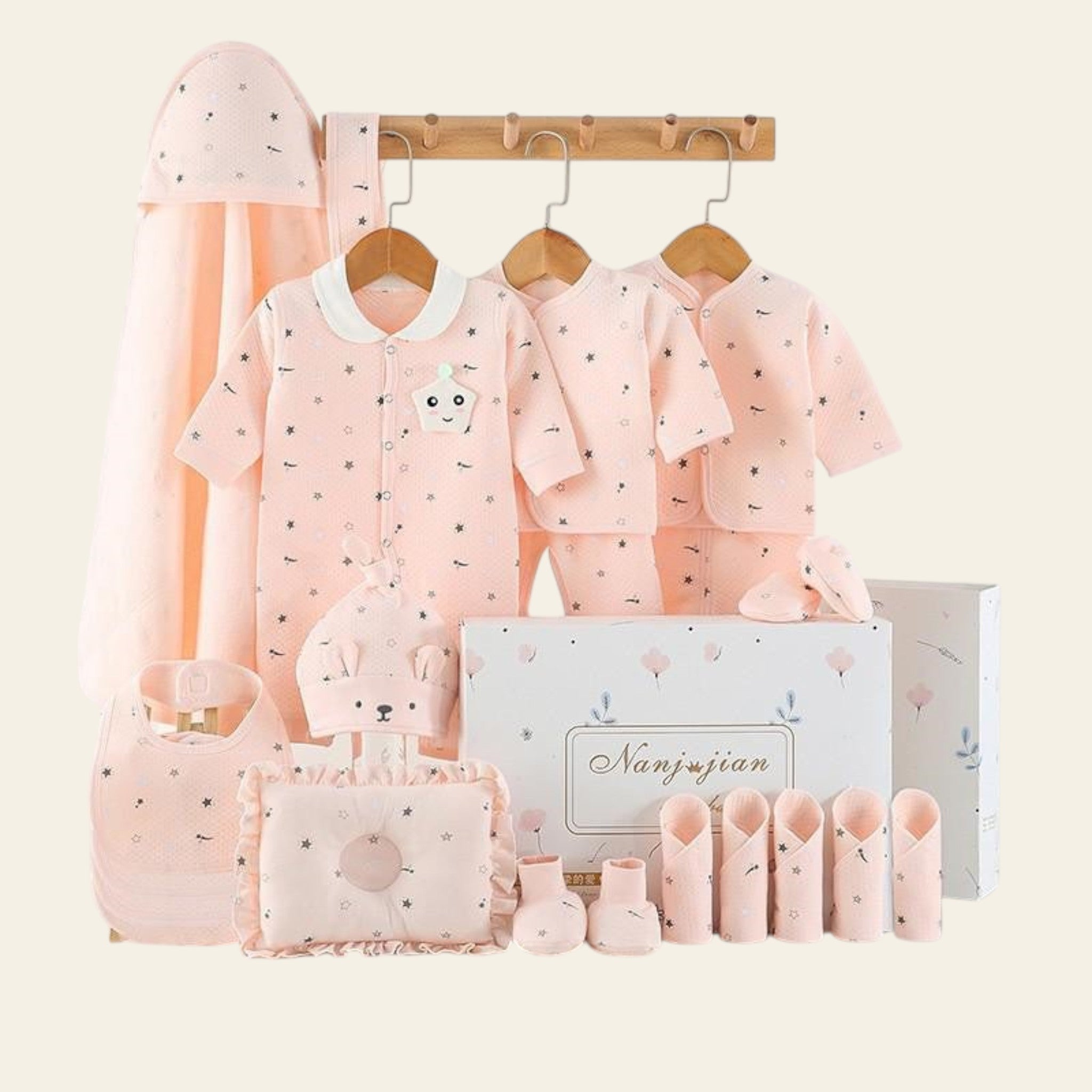 Baby clothing set with pink outfits, hats, and accessories on a white background with 'warm' text.