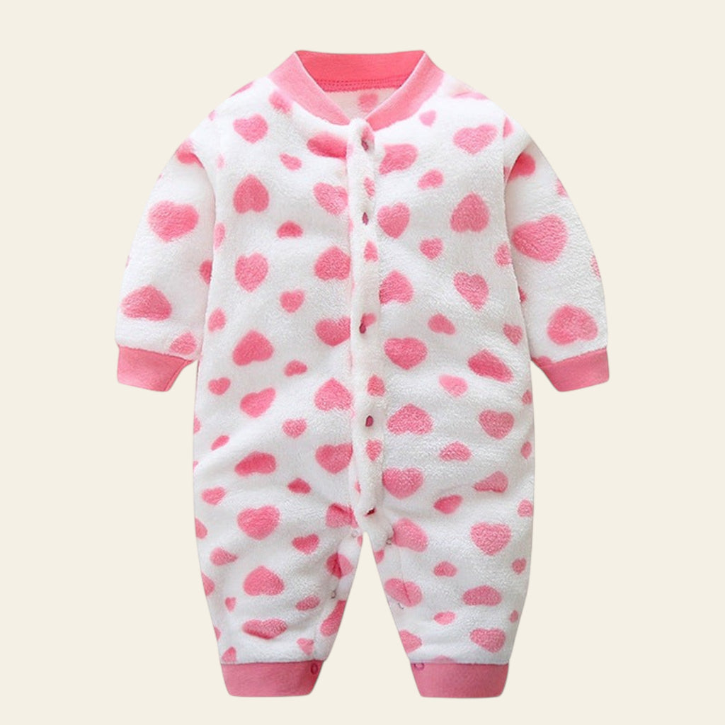 White baby onesie with pink heart patterns on a white background