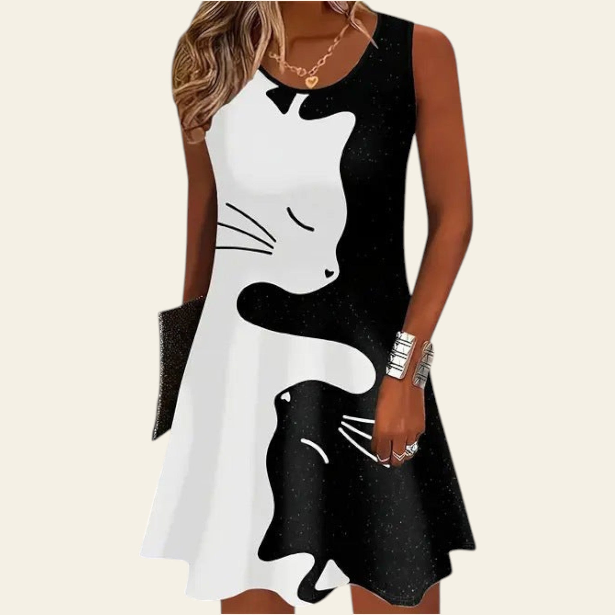 woman wearing a sleeveless black and white dress with a cat graphic design