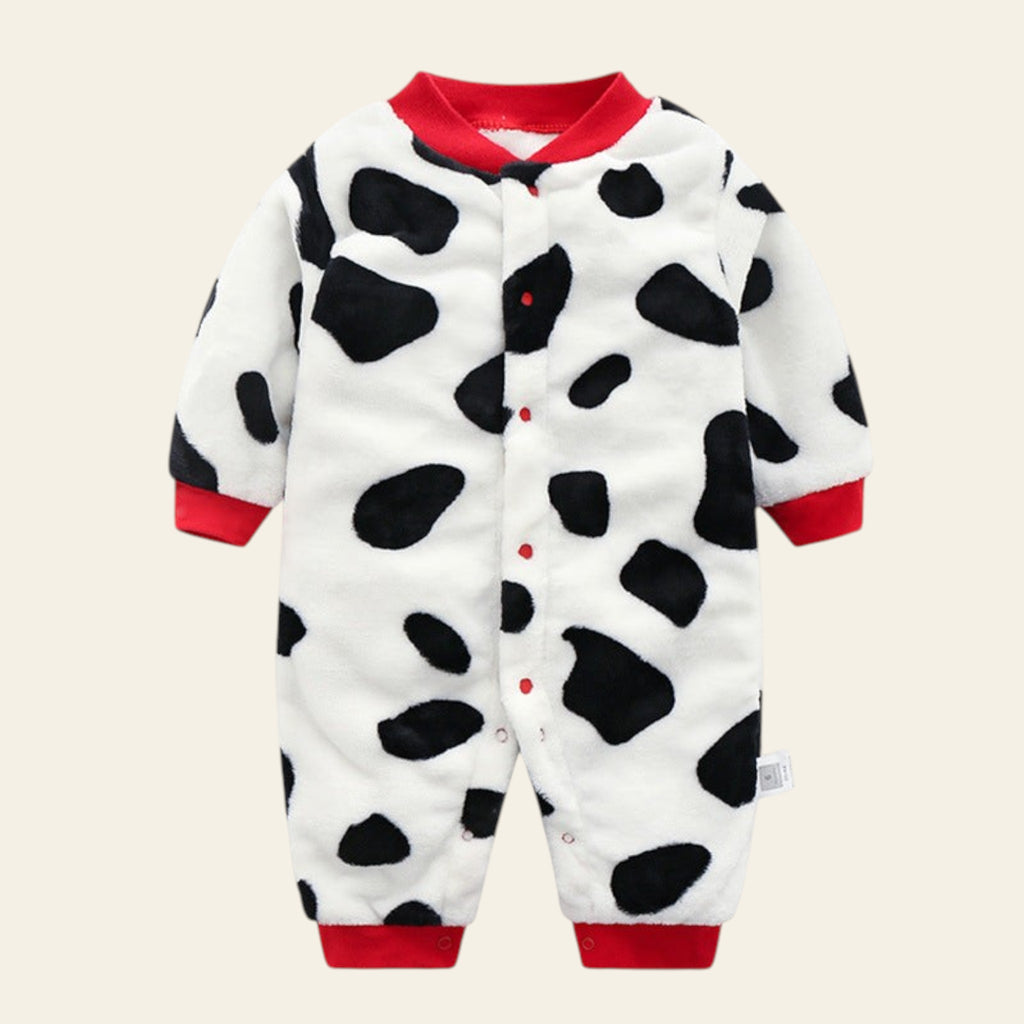 Baby onesie with cow print and red accents on a white background