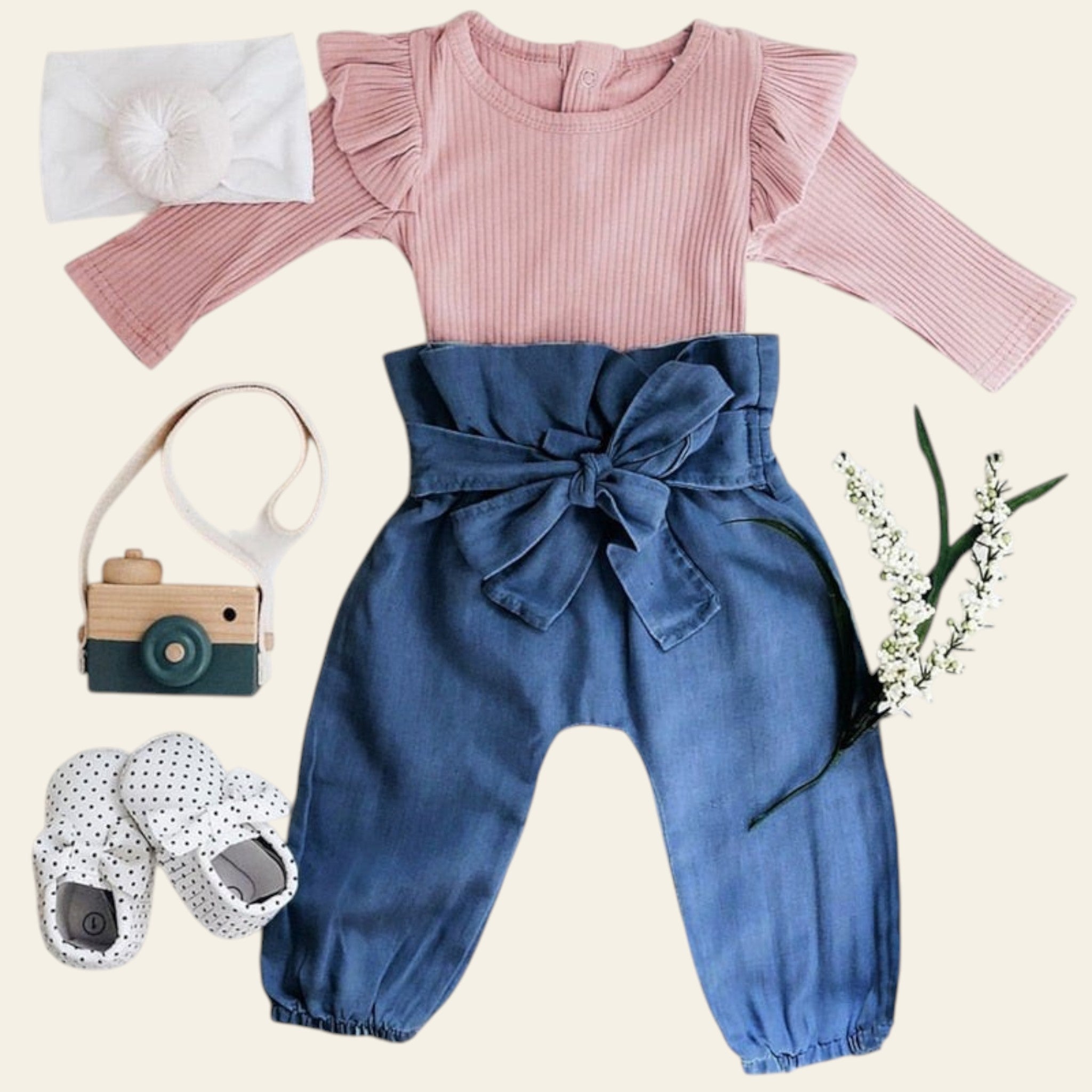 Children's outfit with pink top and blue pants on a white background