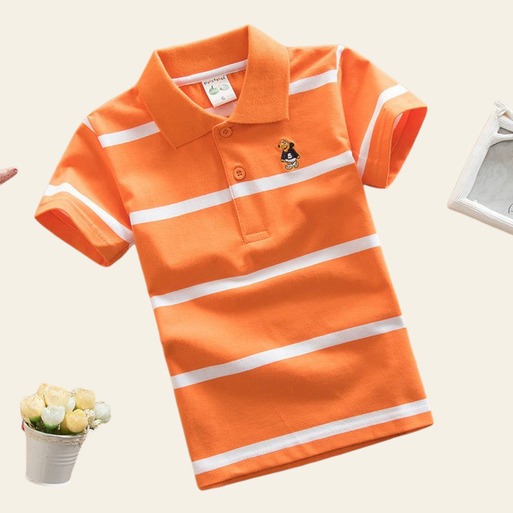 Orange polo shirt with white stripes on a beige surface