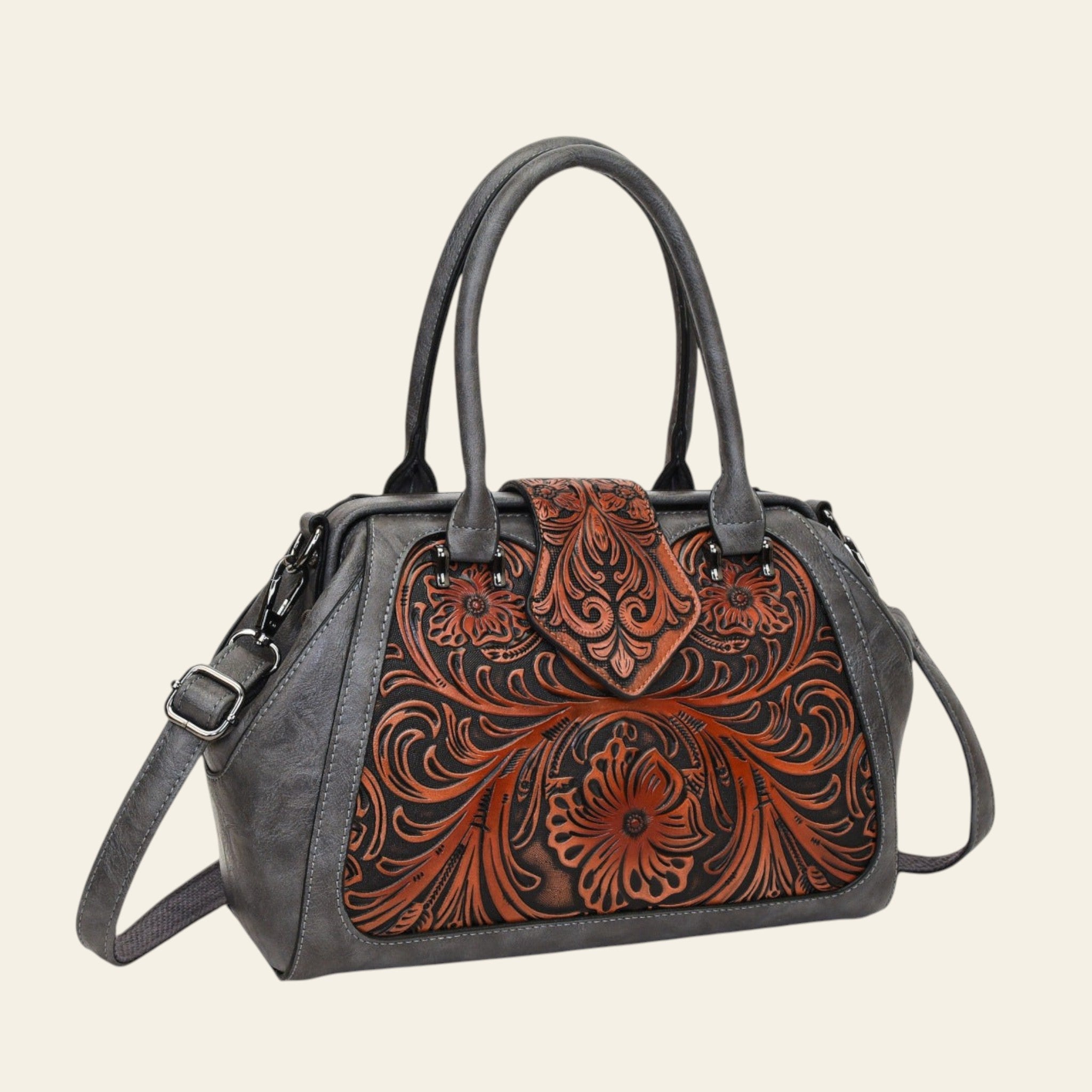 Handbag with floral tooled leather design on a white background