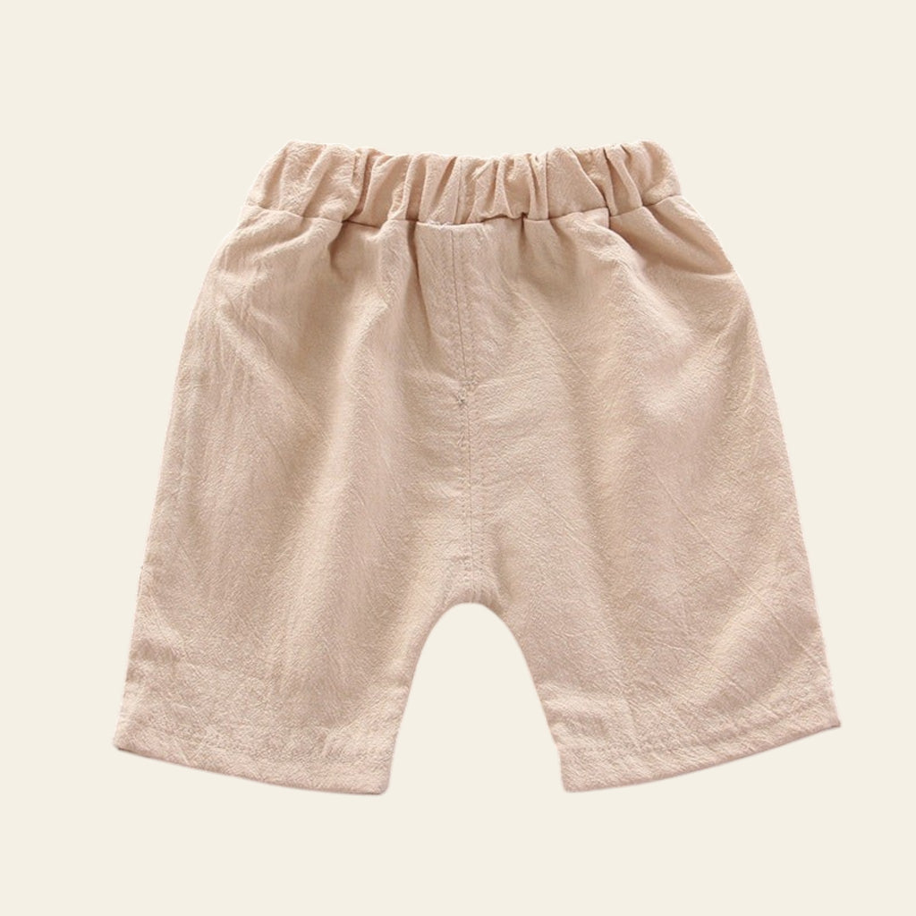 Beige baby shorts on a gray background
