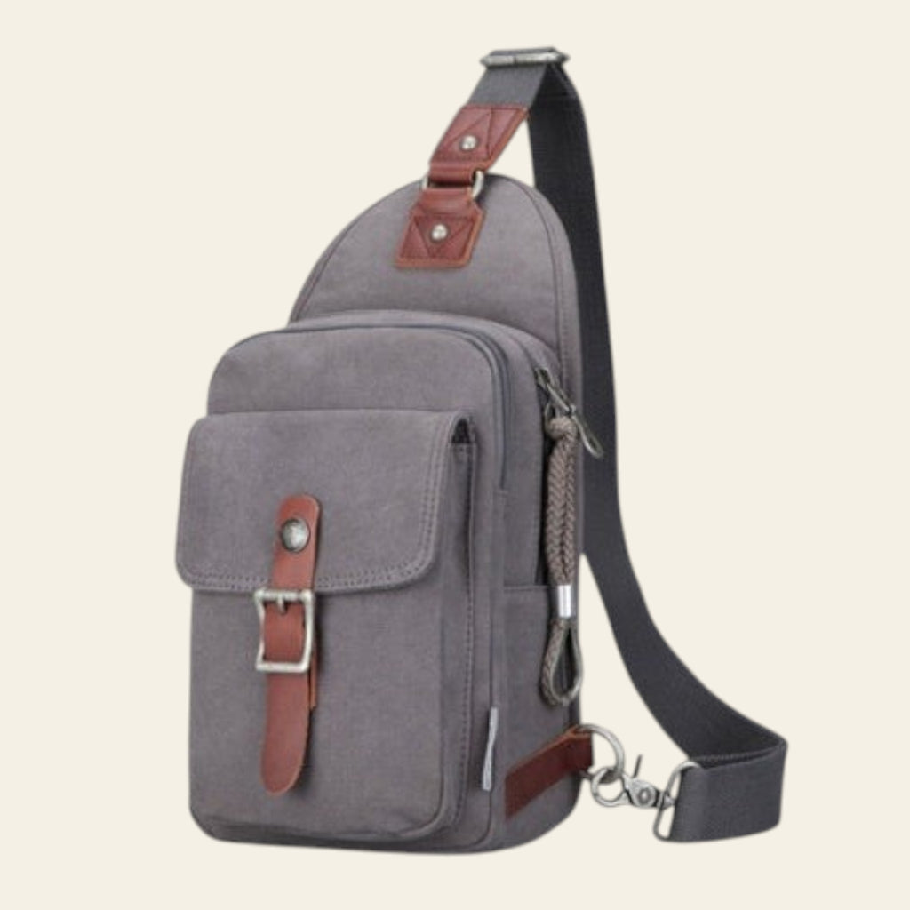 Gray sling bag with brown accents on a white background