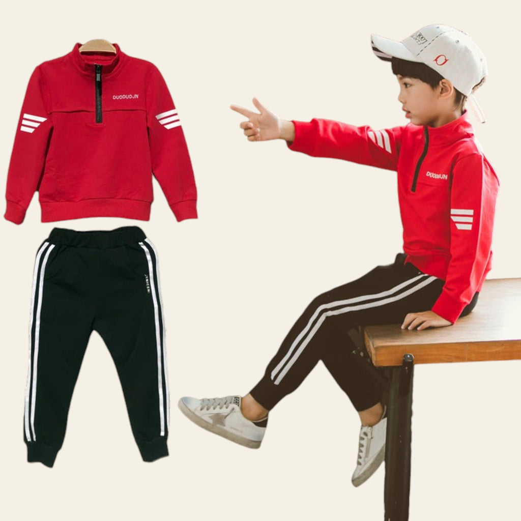 Red tracksuit with white stripes on a dark textured background, child model wearing the tracksuit.