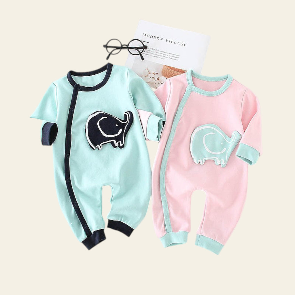 Two baby rompers, one green with an elephant design and one pink with a similar design, on a white background.