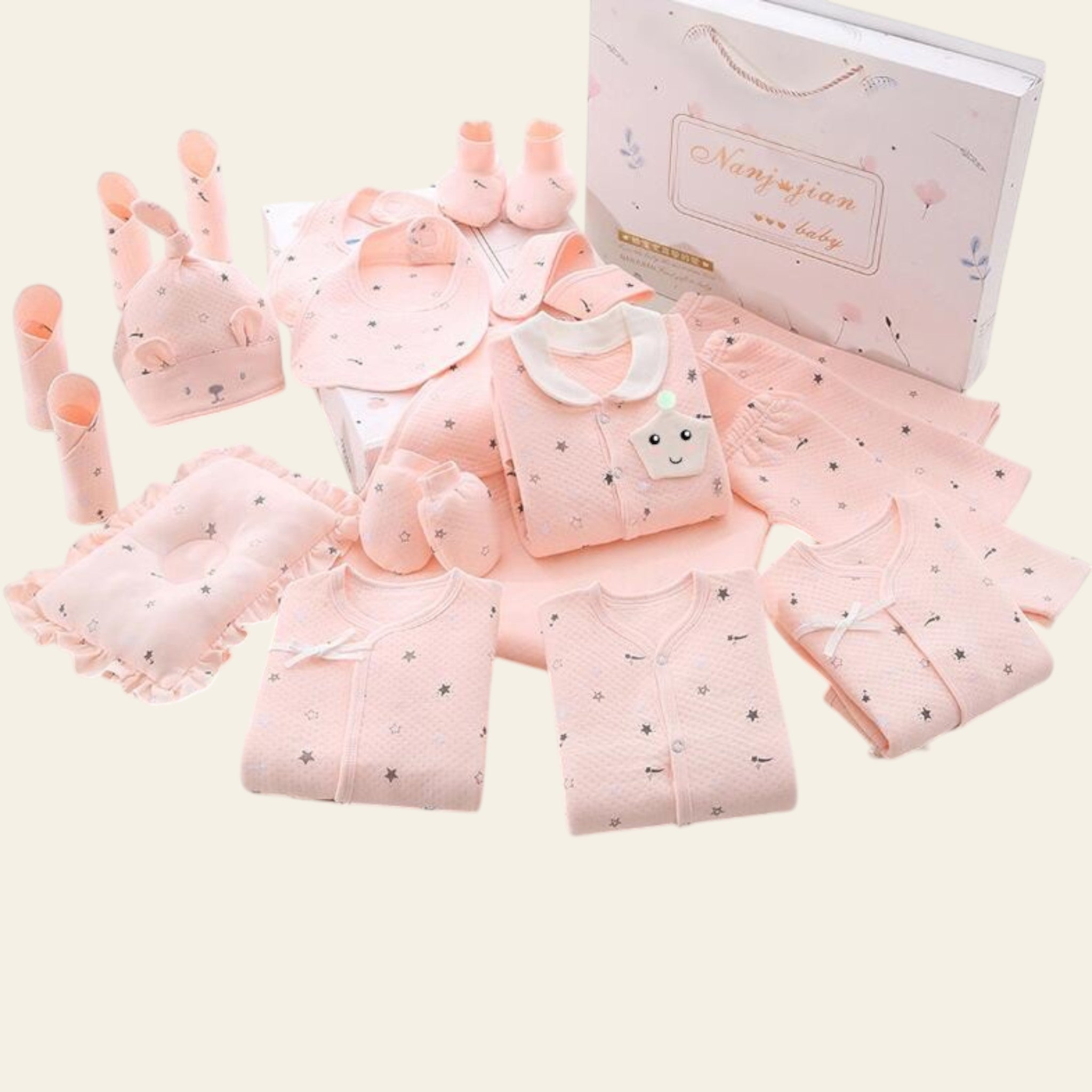 Collection of pink baby clothes and accessories on a white background