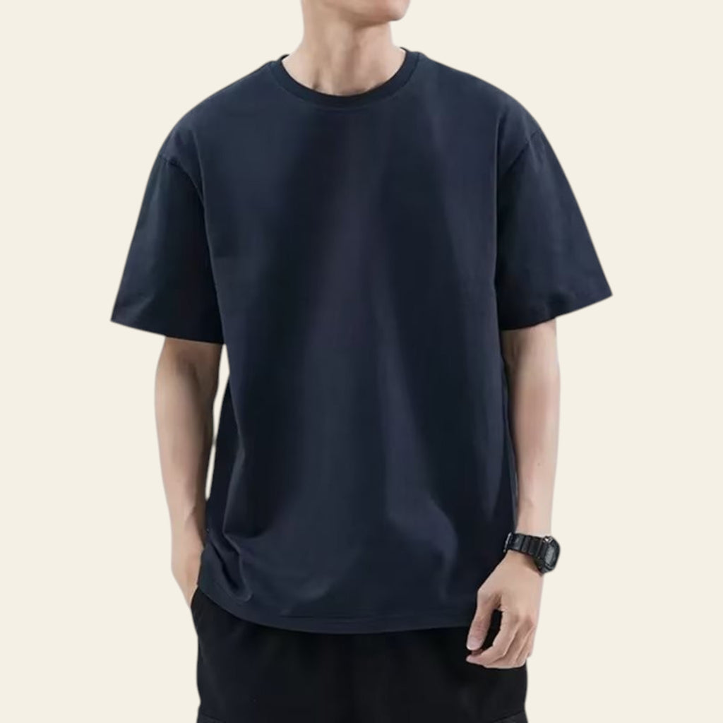 Man wearing a navy blue loose fit solid color t-shirt