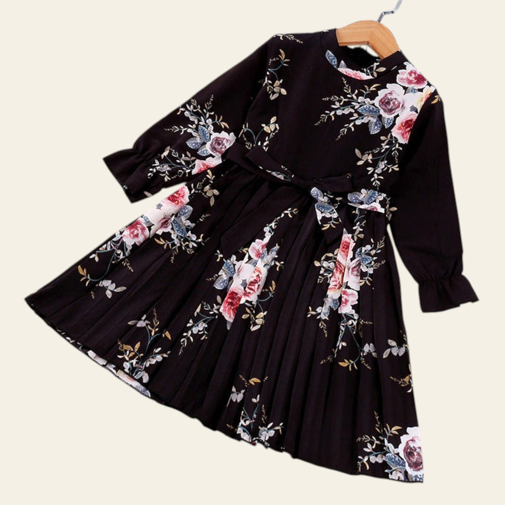 Black dress with floral pattern on a white surface