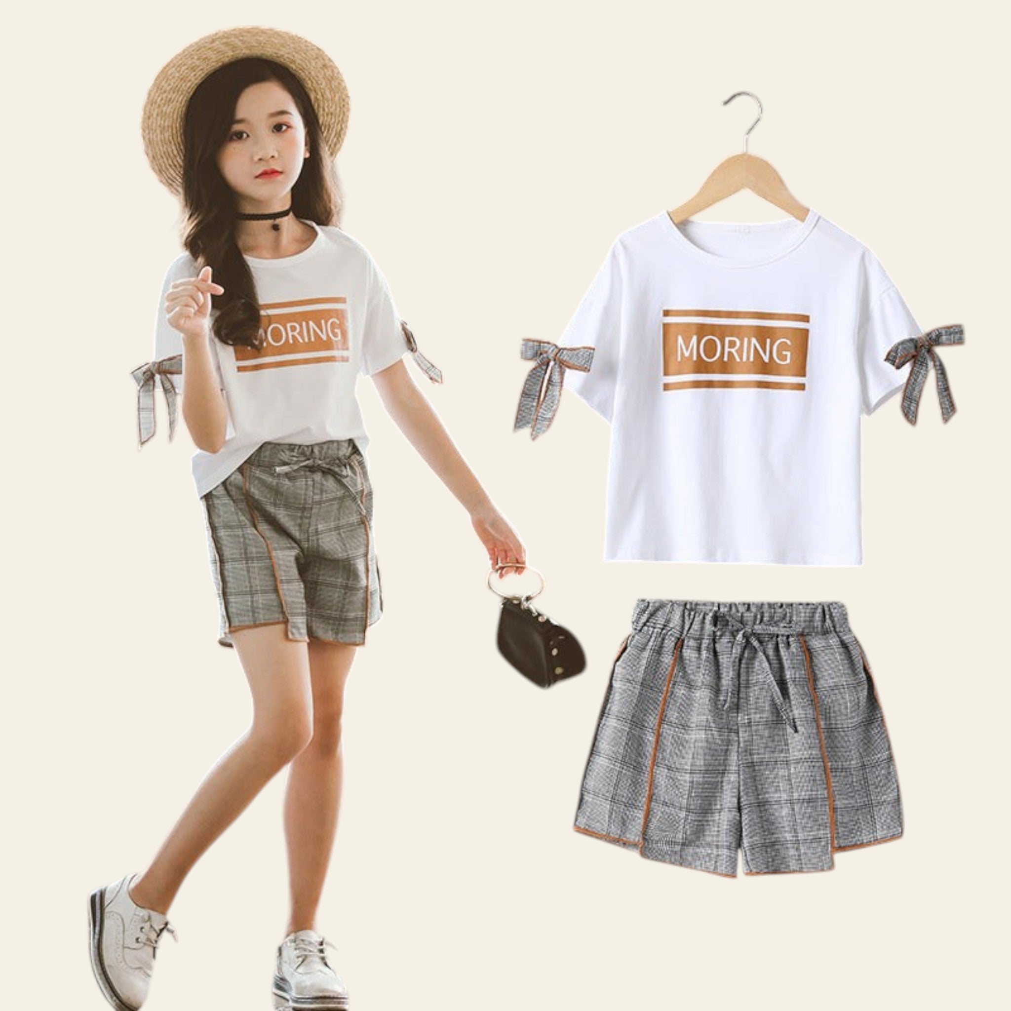 Woman wearing a white t-shirt with 'MORING' text and plaid shorts, standing next to the clothing items.