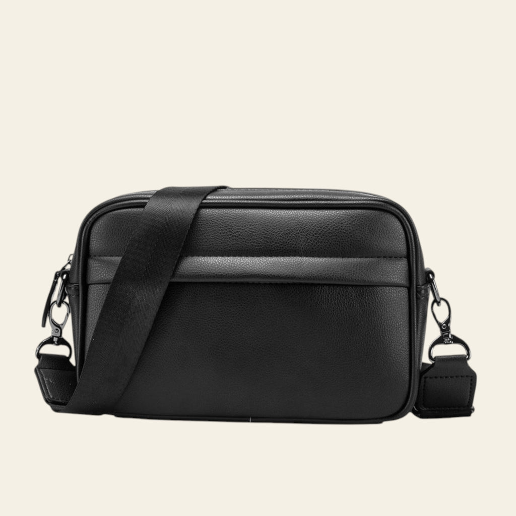 Black leather crossbody bag on a white background