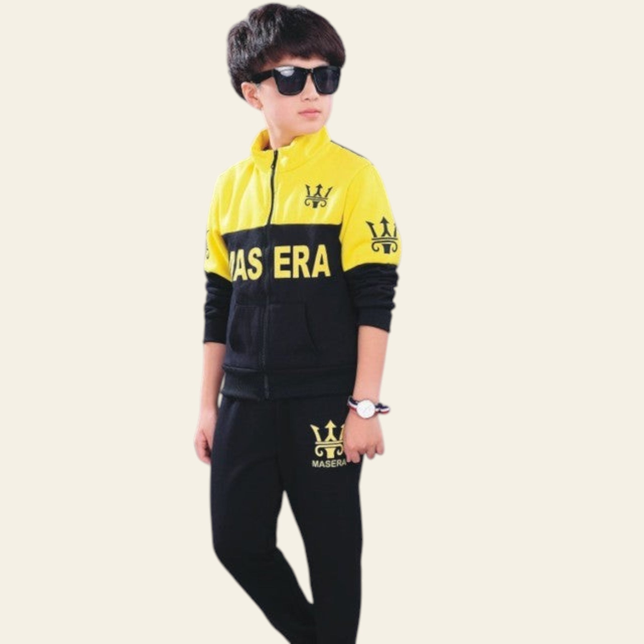 Child wearing a yellow and black tracksuit with 'Maserati' branding on a gray background