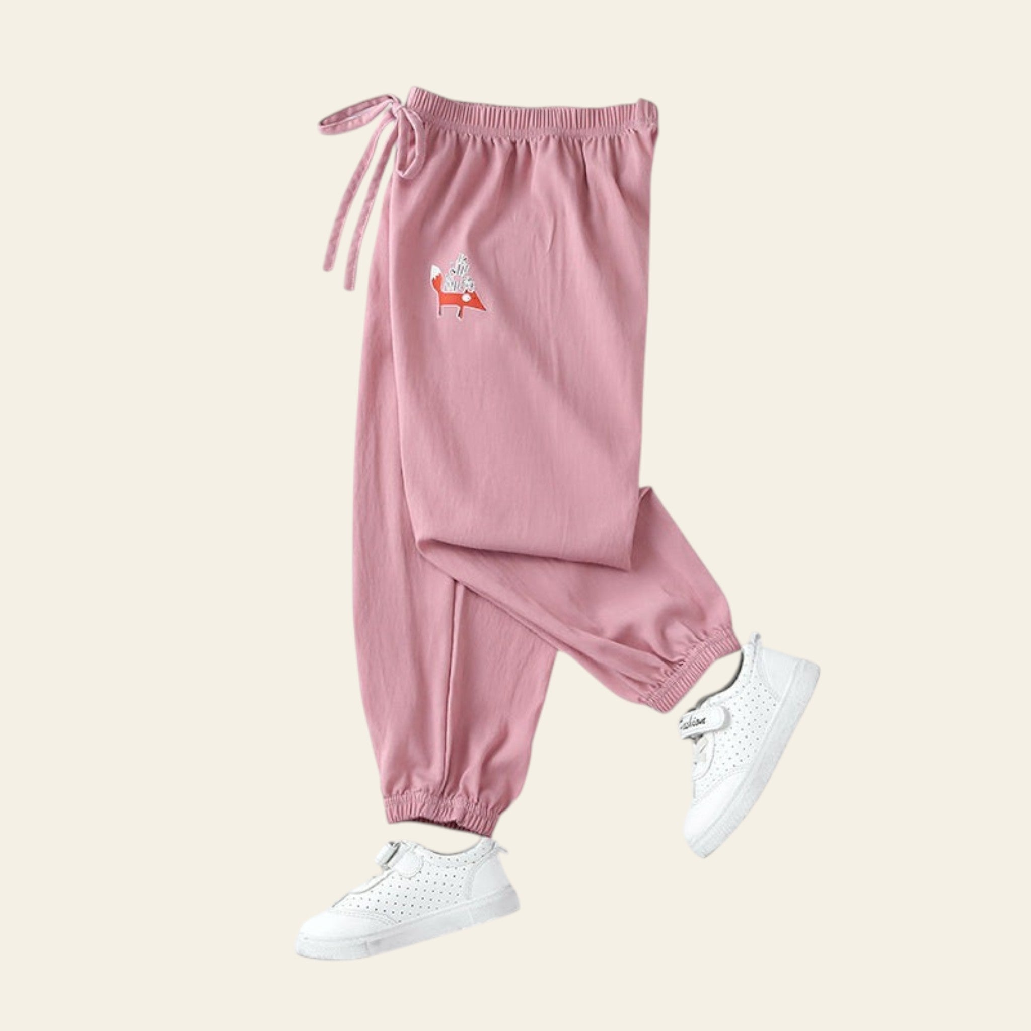 Pink sweatpants with a small design on a white background
