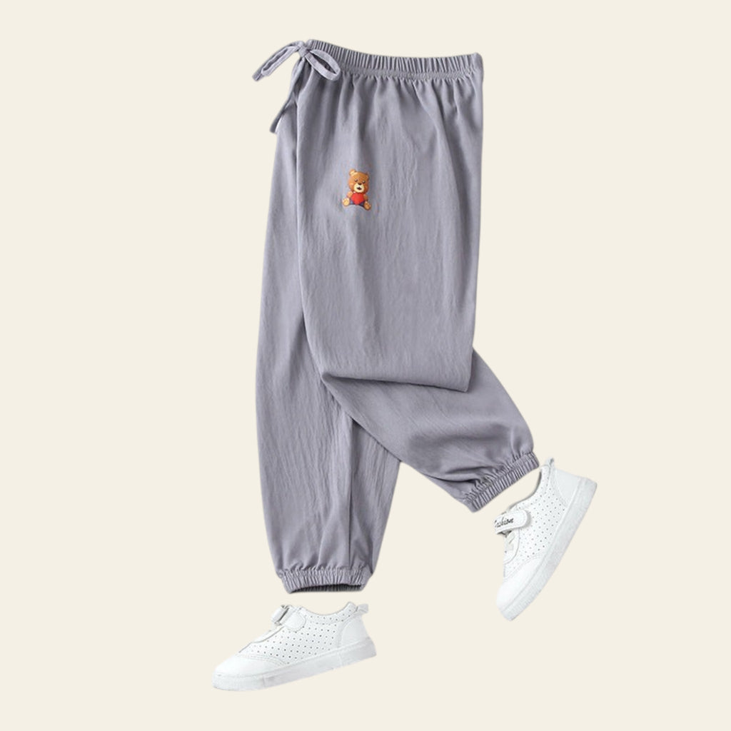 Gray pants with a small bear patch on a white background