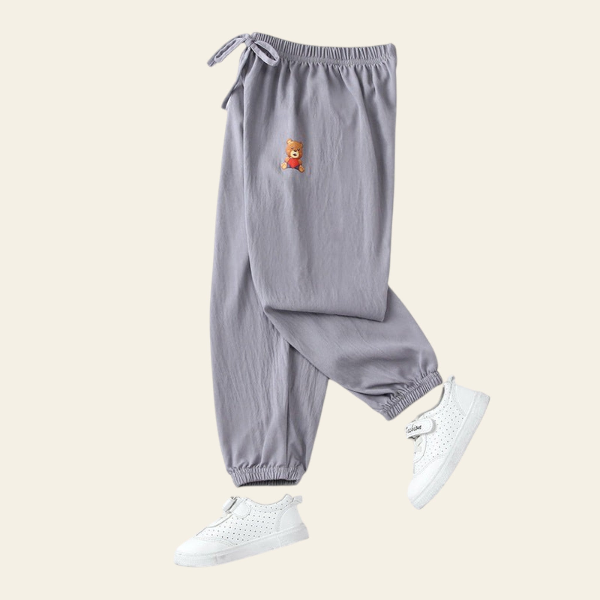 Gray pants with a small bear patch on a white background
