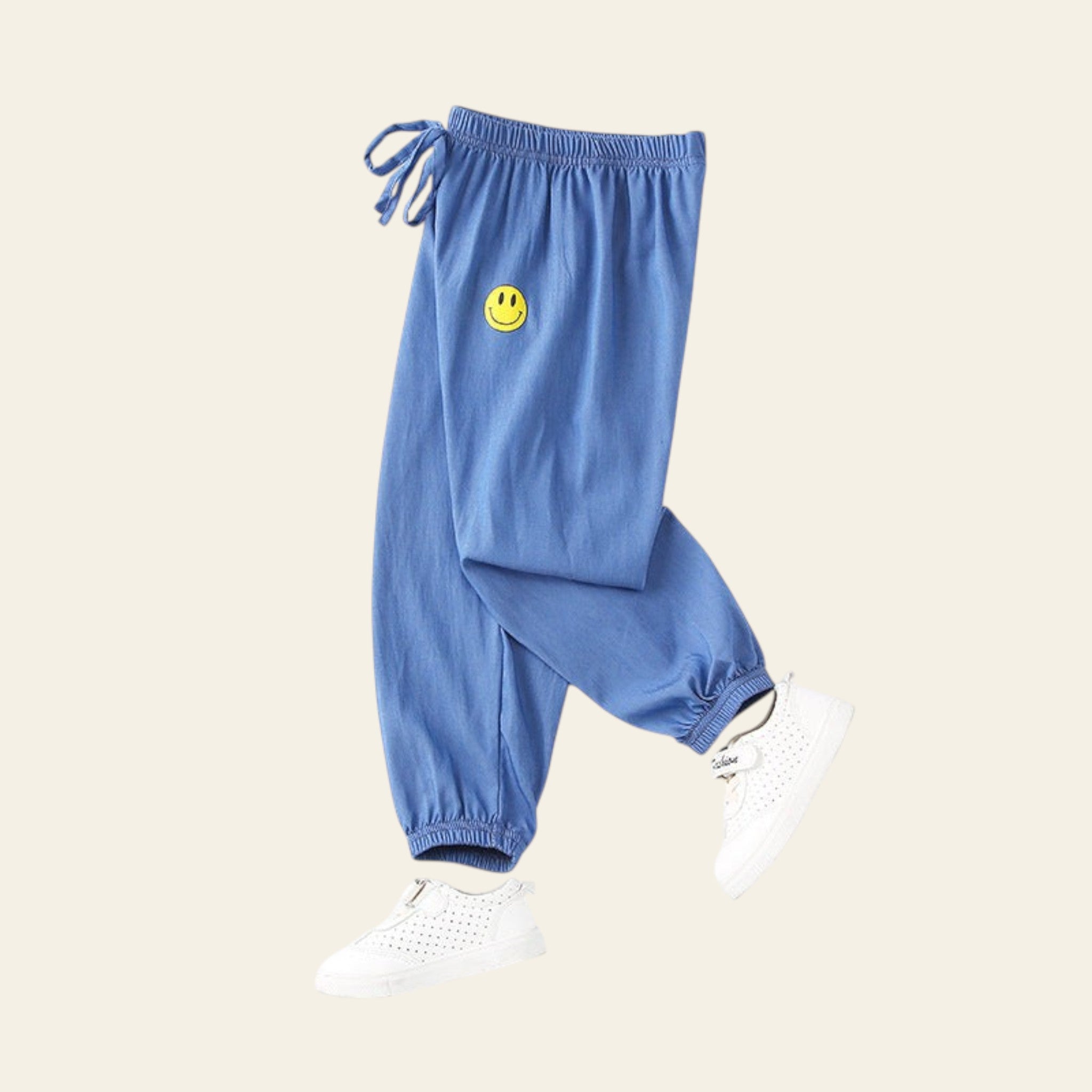Blue pants with a smiley face patch on a white background