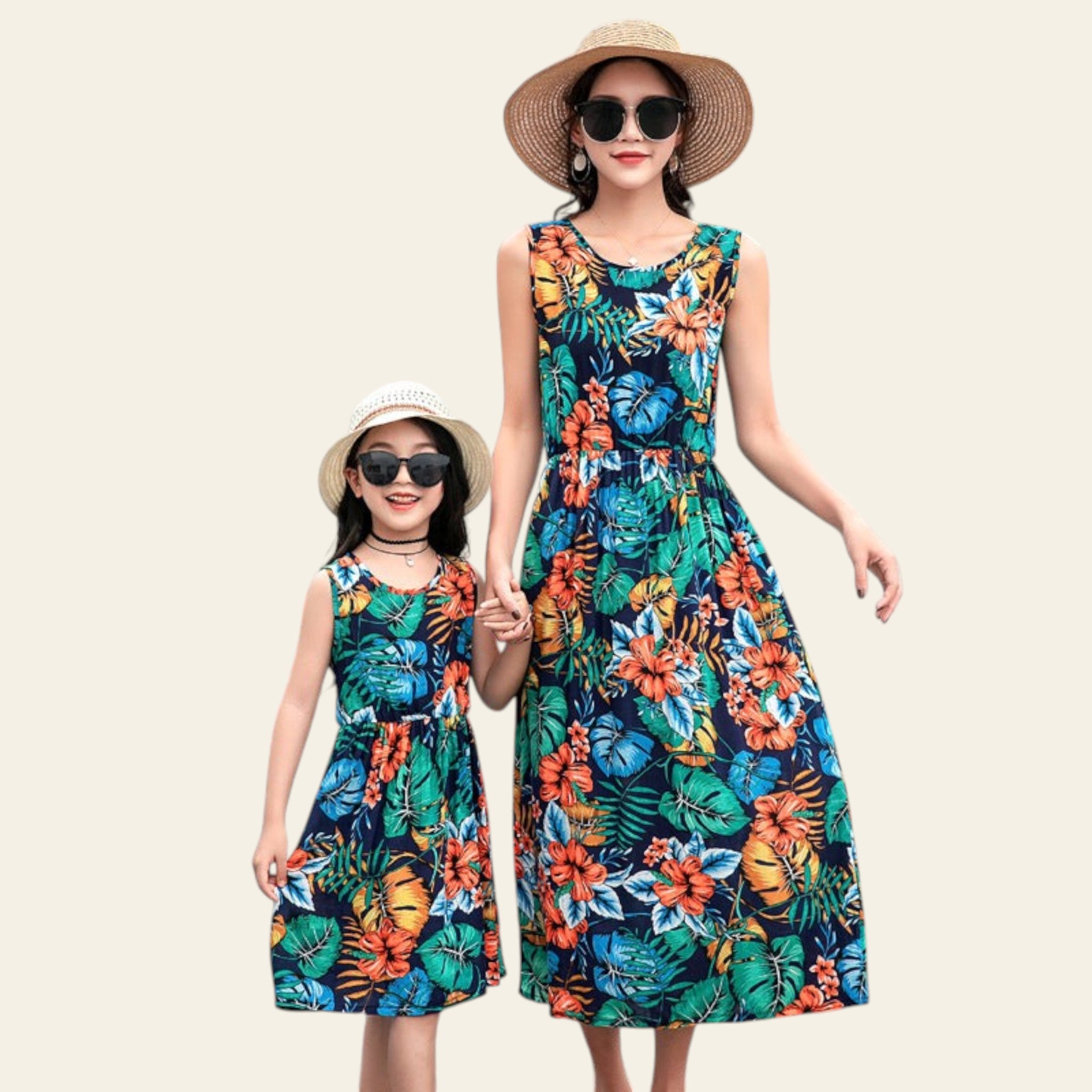 Two women in matching floral dresses standing by a poolside.