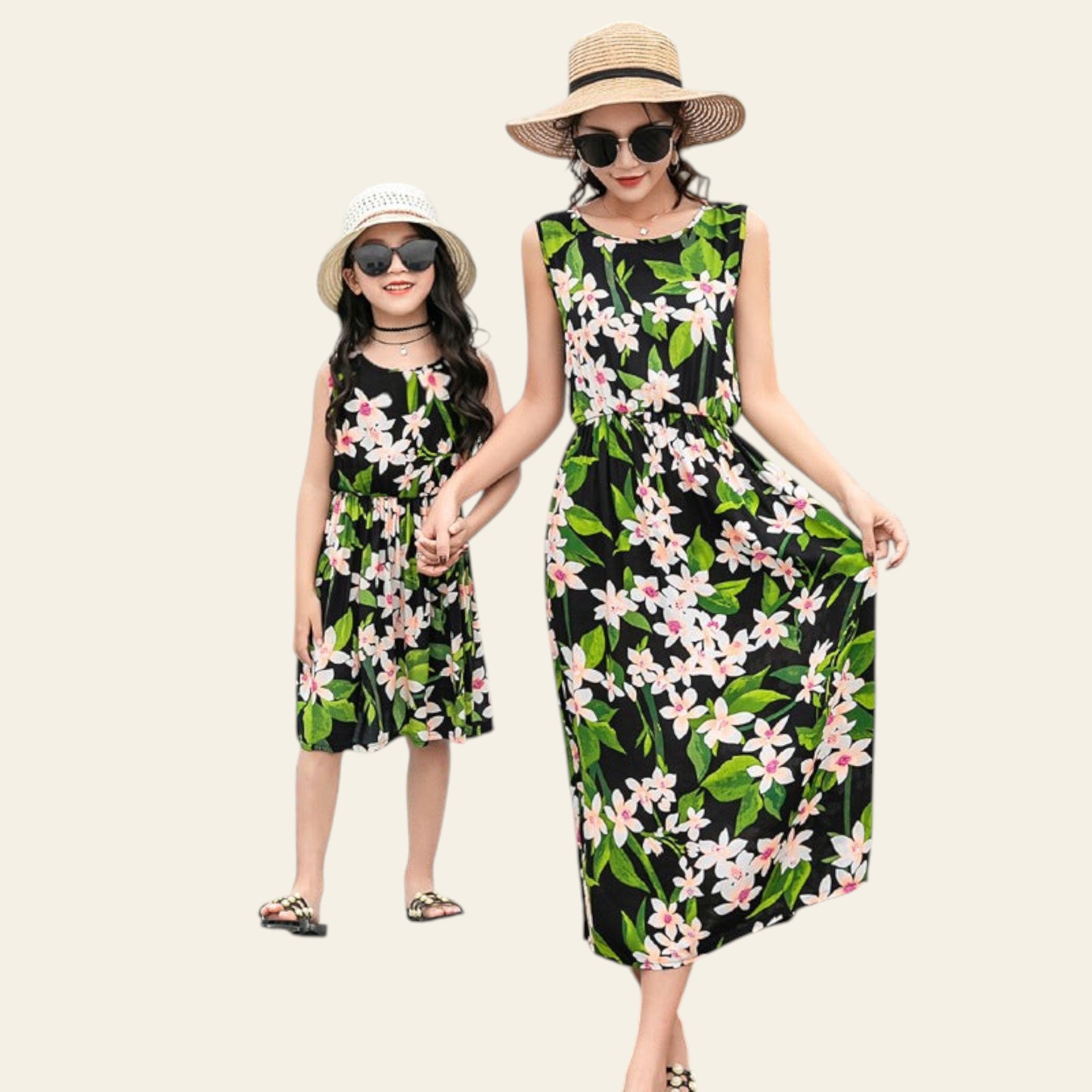 Two women in matching floral dresses by a poolside.