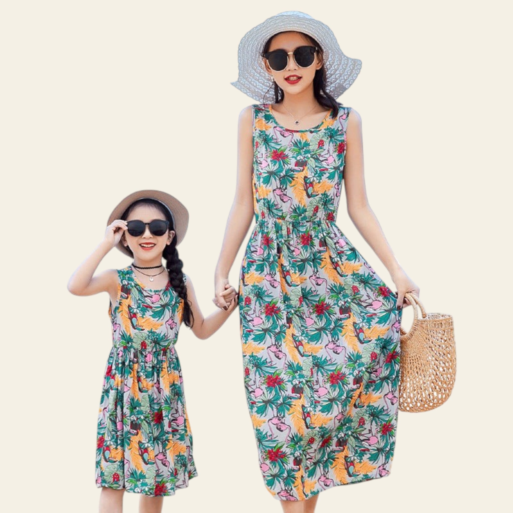 Two women in floral dresses on a beach with sunglasses and hats.