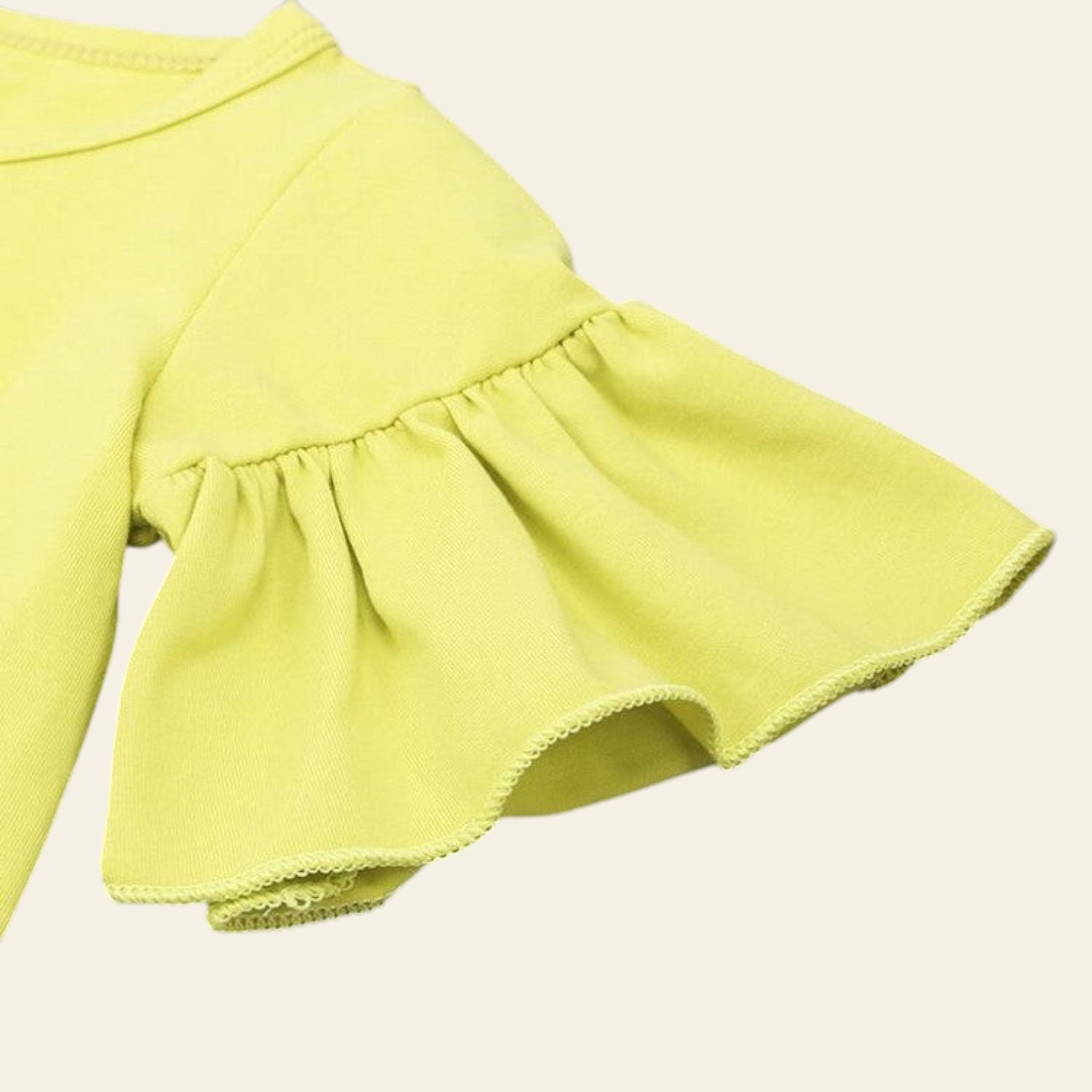 Yellow ruffled skirt on a gray background