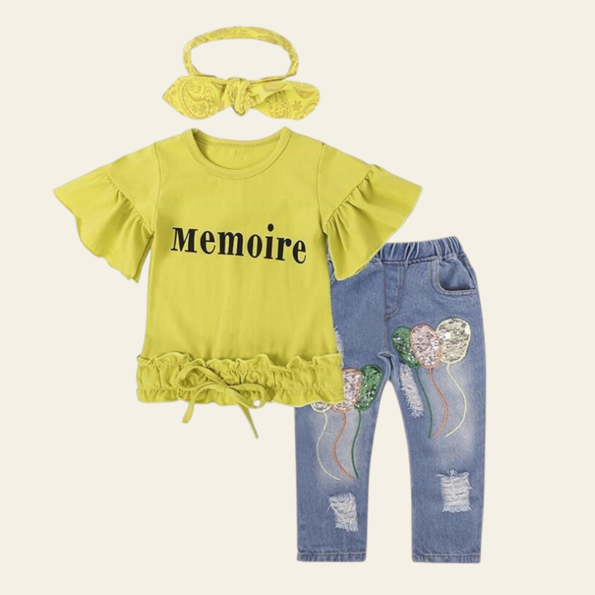 Children's outfit with yellow top, blue jeans, and headband on a white background
