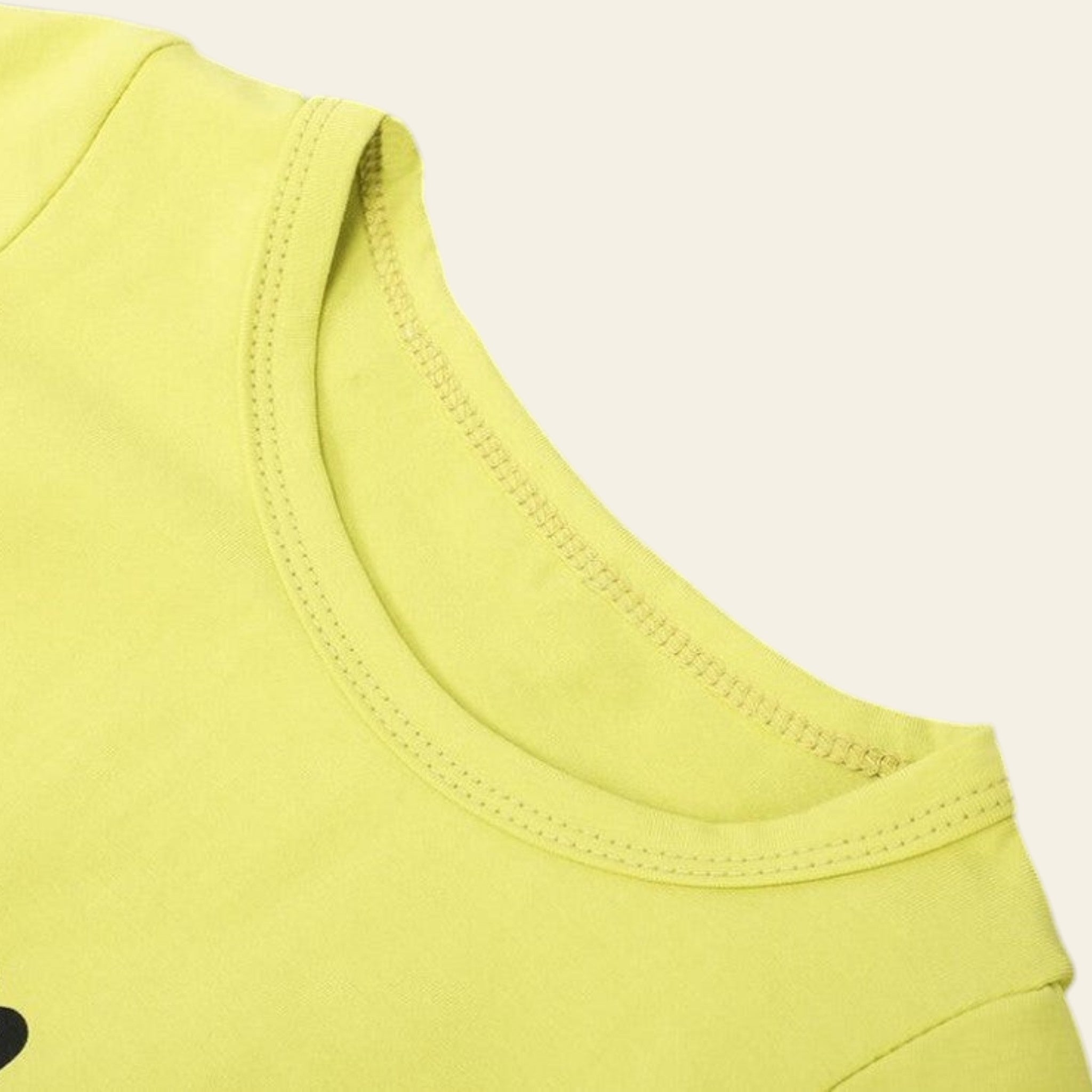 Close-up of a yellow sleeveless top on a gray background