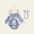 Baby girl's floral dress set with bloomers and headband on a gray background