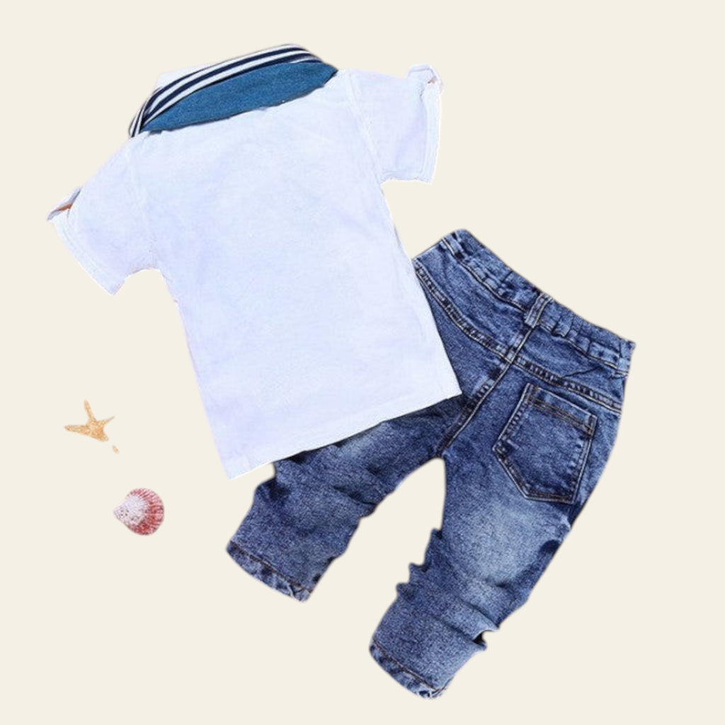 Children's outfit with white shirt and blue jeans on a beige background