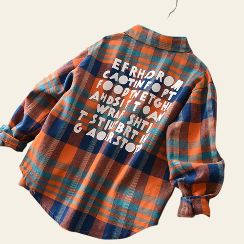Plaid shirt with text on a wooden floor