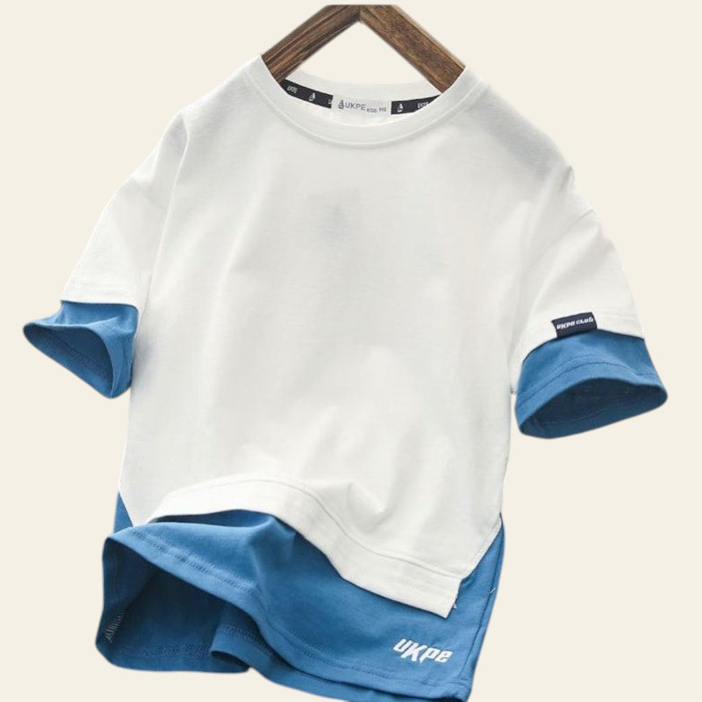 White and blue shirt with rolled-up sleeves on a hanger against a grid background