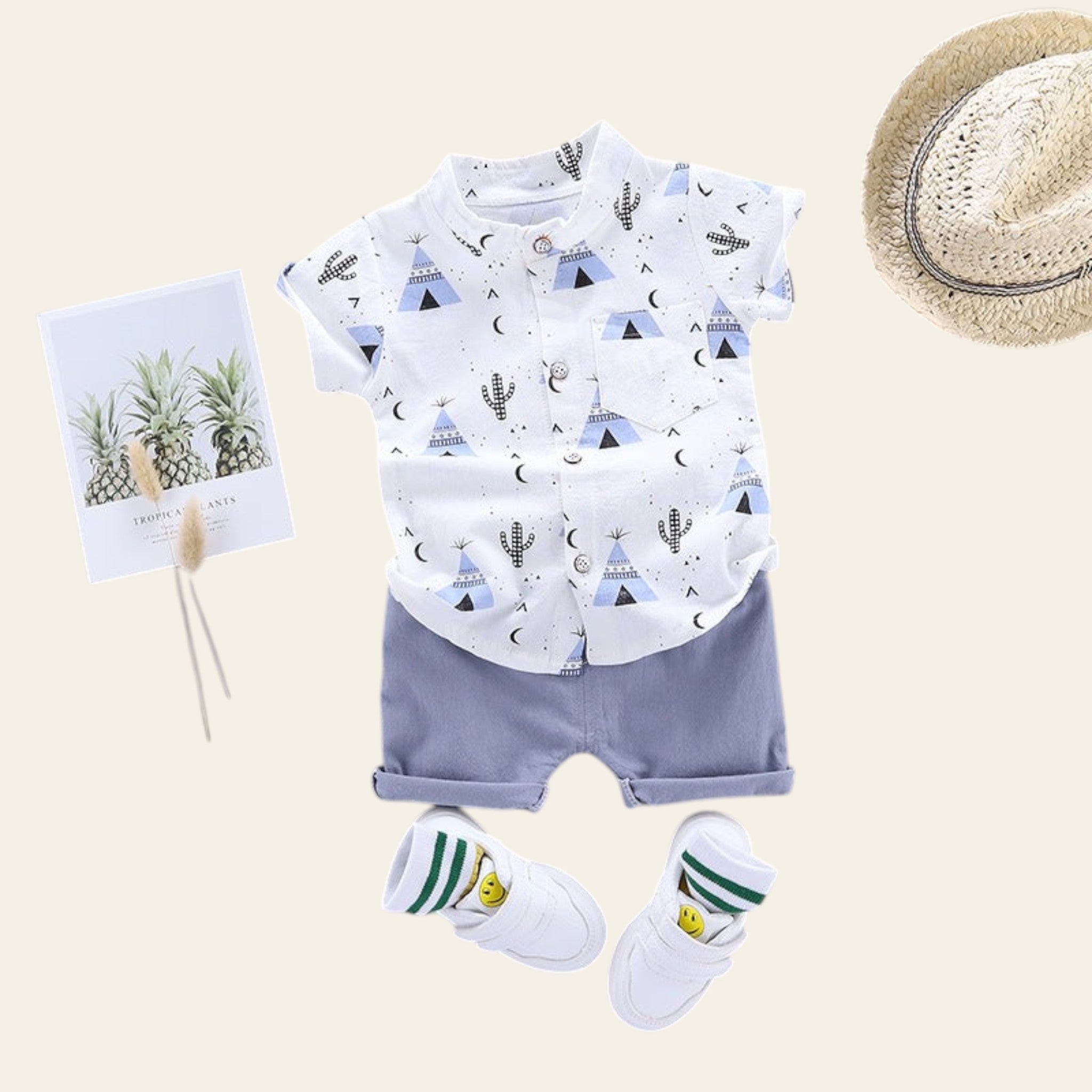 Children's outfit with t-shirt, shorts, socks, and hat on a gray background