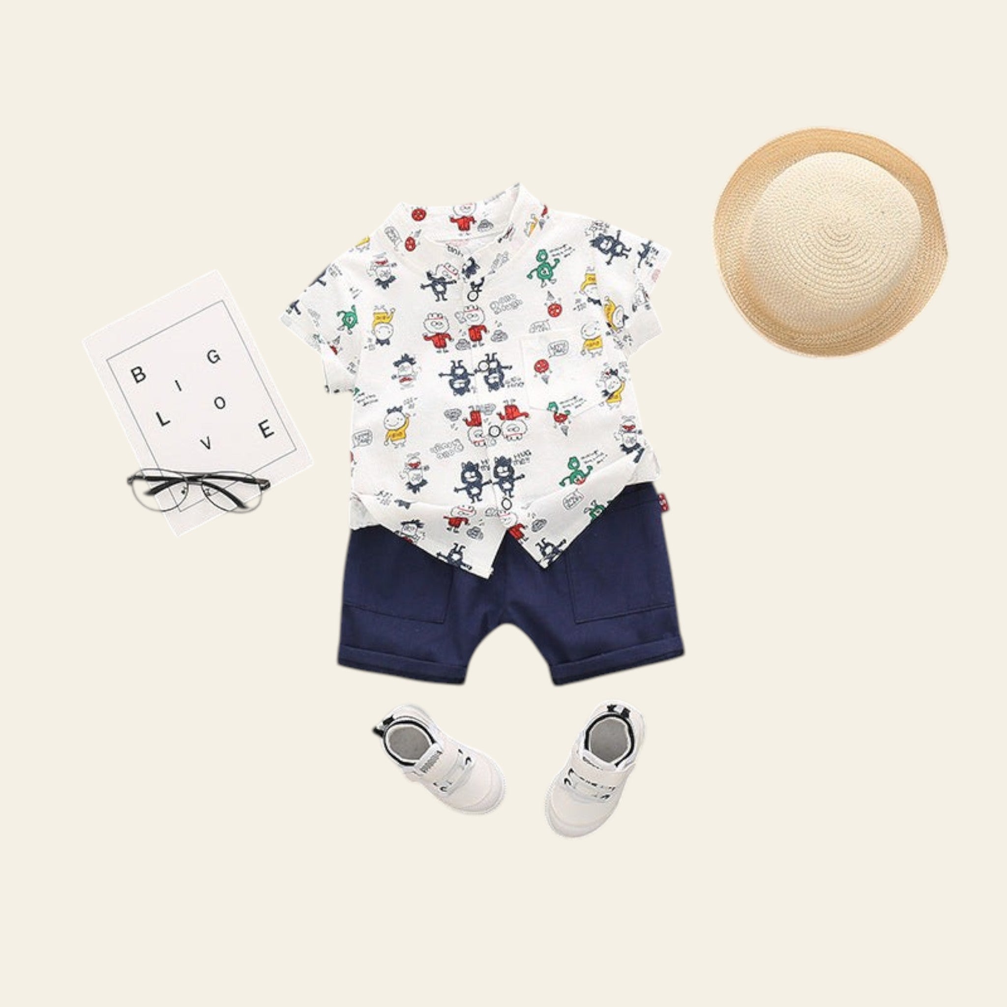 Children's outfit with a patterned shirt, navy shorts, white shoes, and a hat on a gray background.